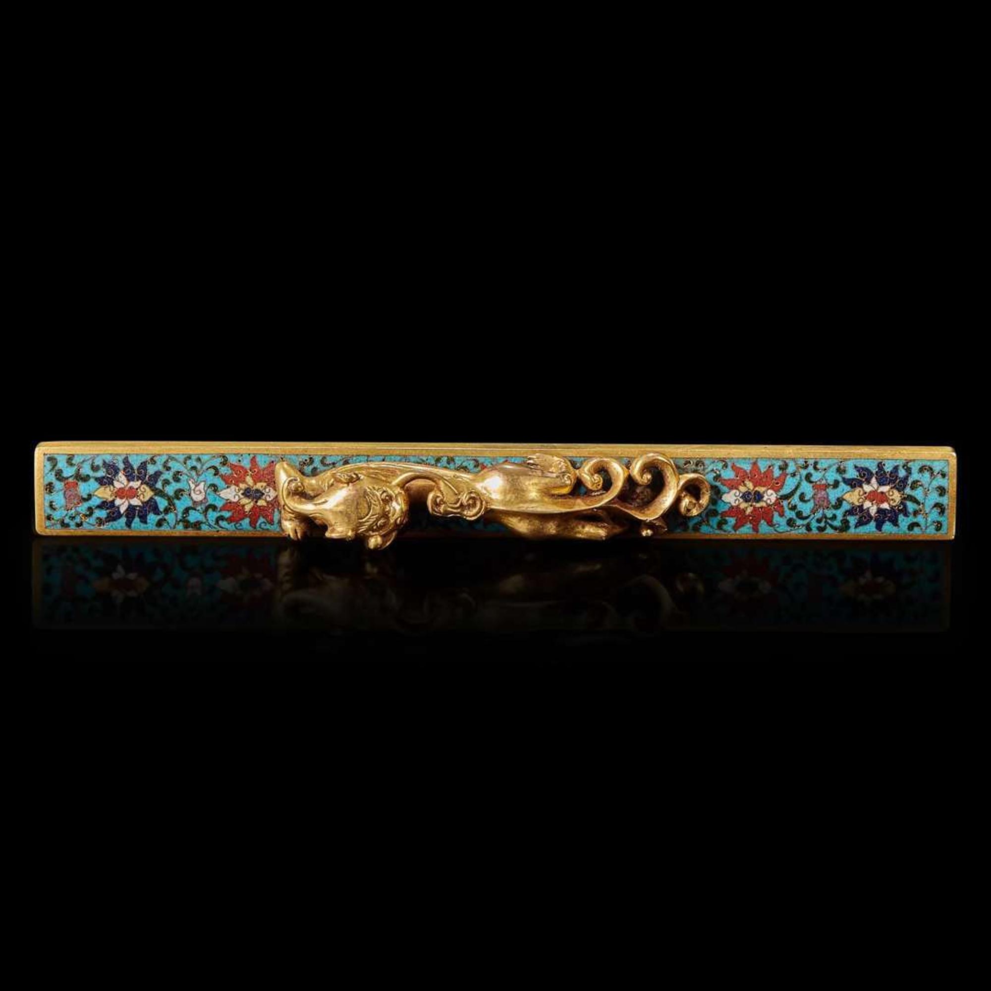 A Chinese gilt-bronze and cloisonné "Qilong" scroll weight