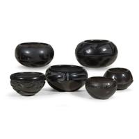 Group of six San Ildefonso and Santa Clara blackware items 20th century