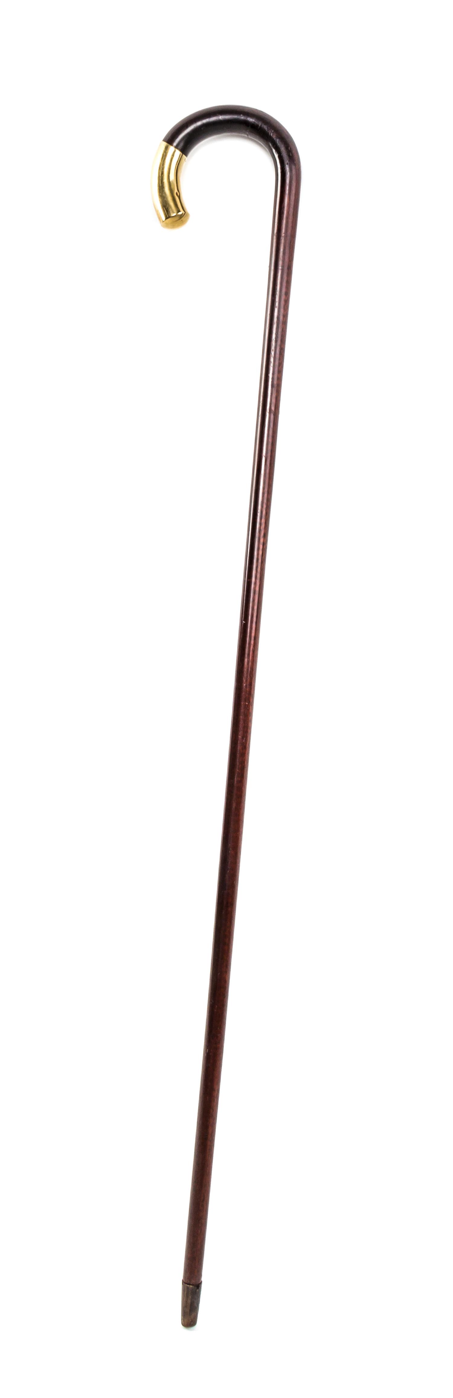 A 14 Karat Gold Capped Cane, Length of cap 2 1/2 x length overall 34 1/2 inches.