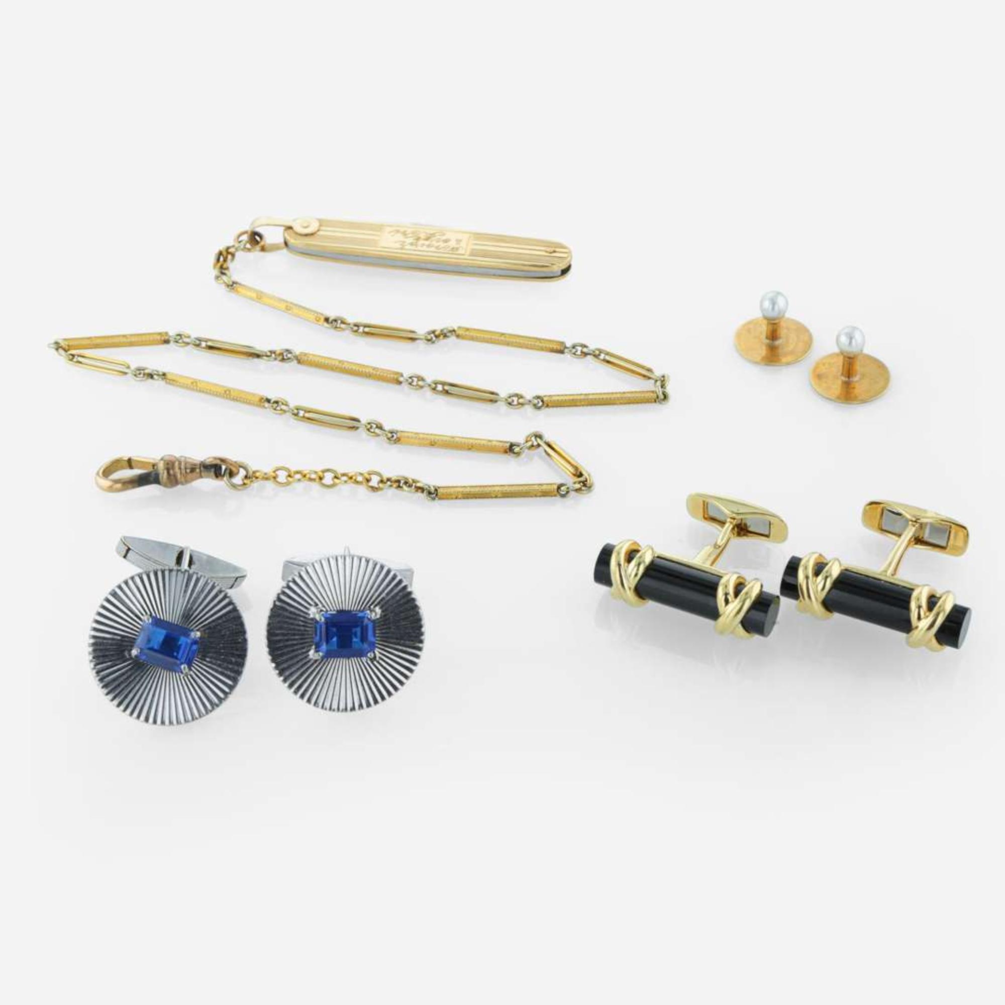 A collection of men's gold accessories