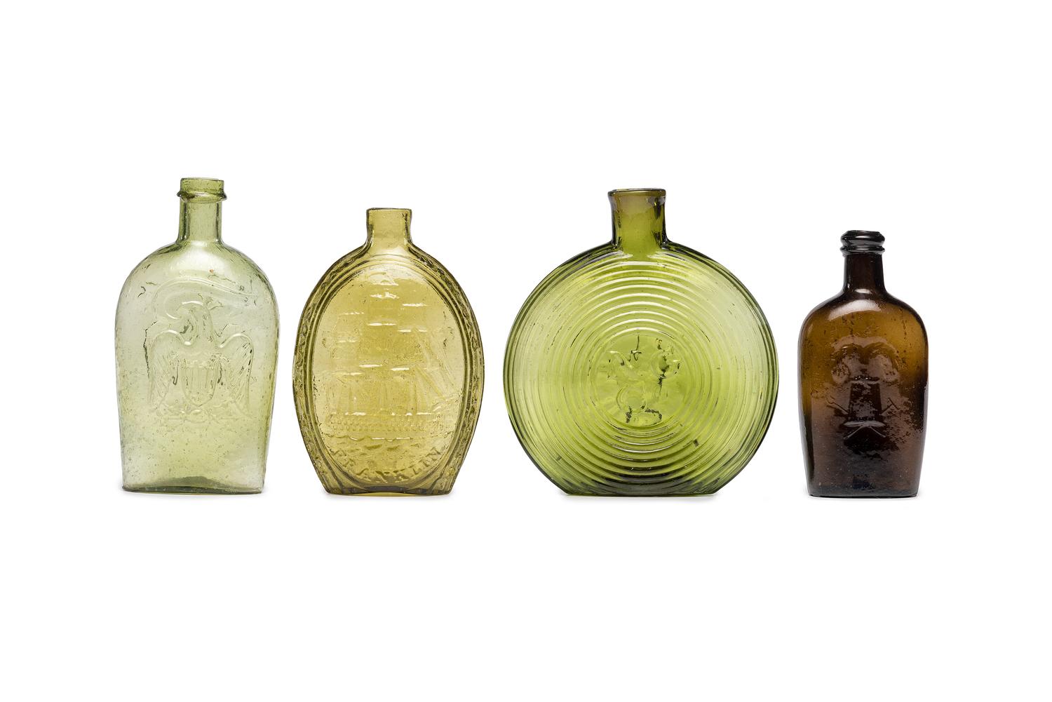 Four Molded Glass Amber and Green Flasks