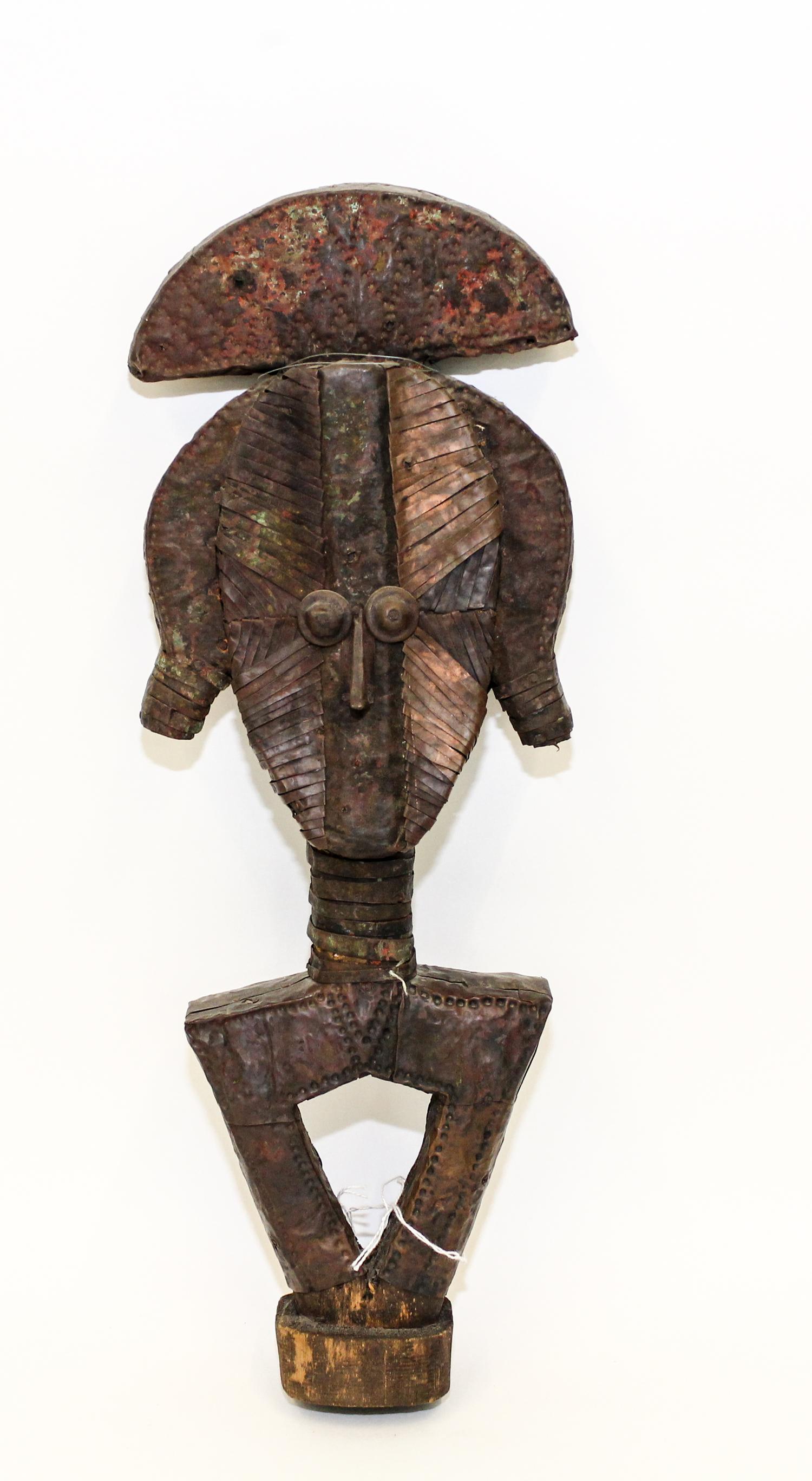 A Metal Clad Carved African Figure Height 19 1/2 inches. — MID TO LATE 20TH CENTURY