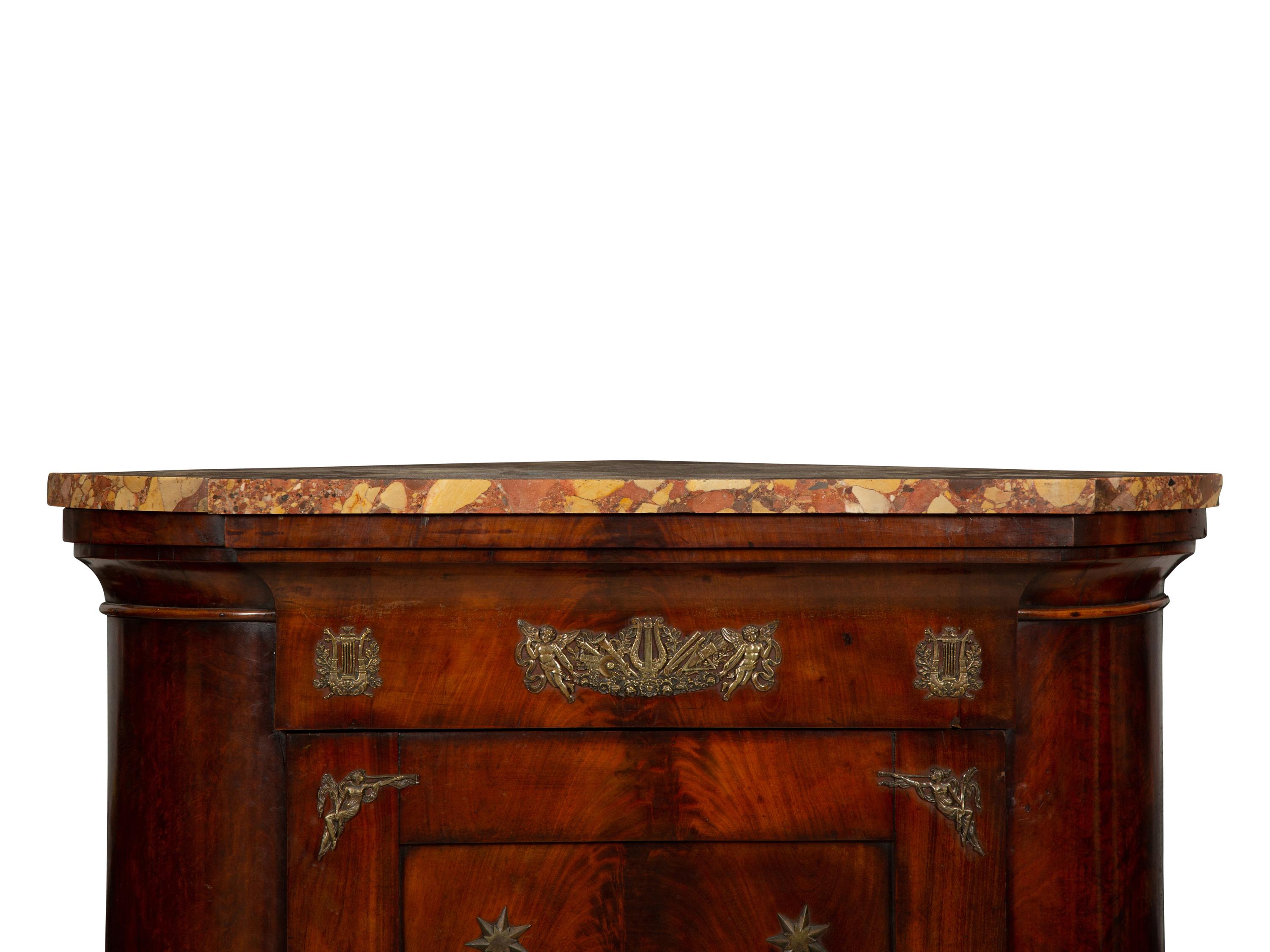 An Empire Gilt Bronze Mounted Mahogany Encoignure with a Brèche d'Alep Marble Top