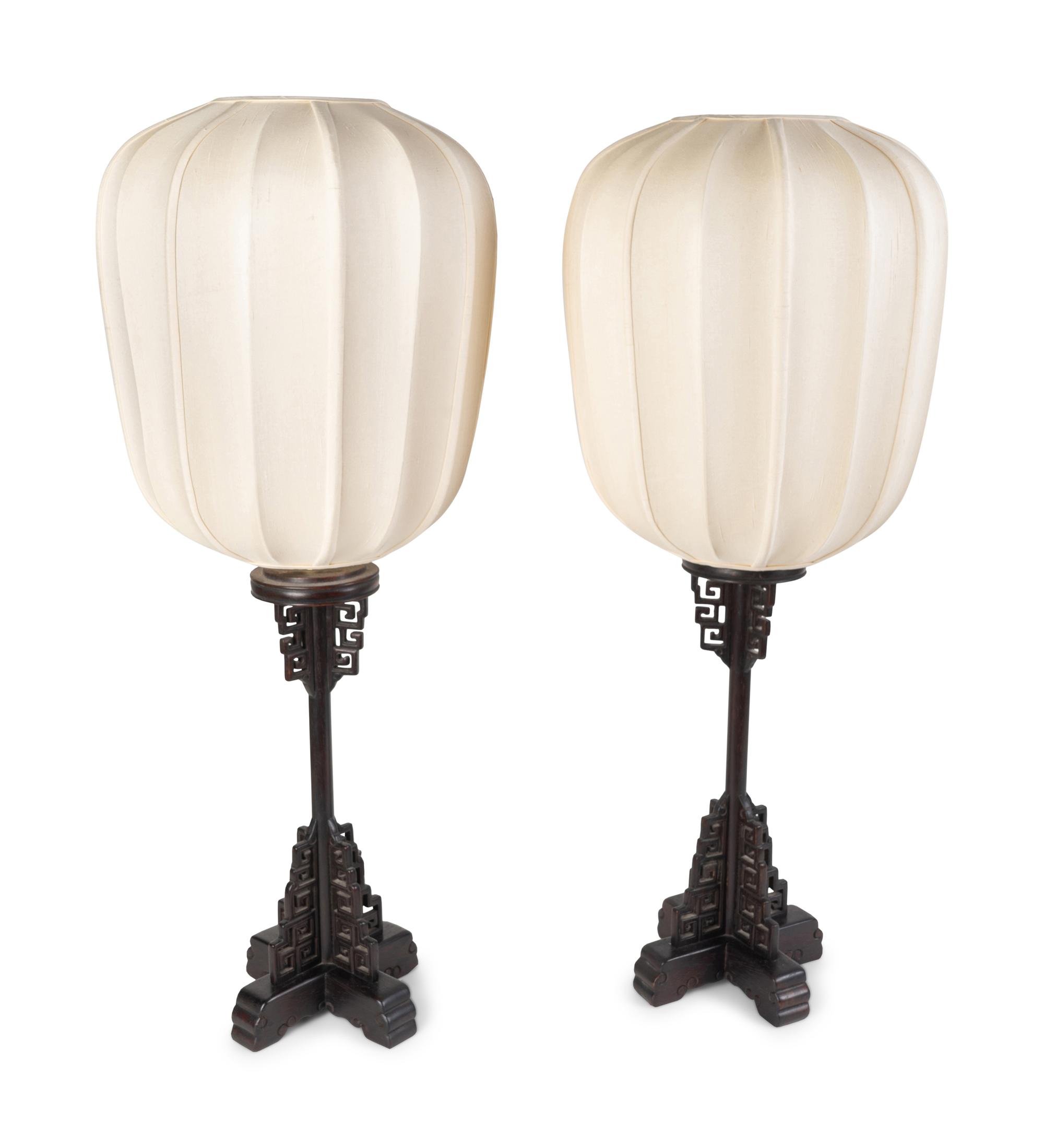 A Pair of Chinese Style Pierced and Ebonized Wood Table Lamps — MID-20TH CENTURY