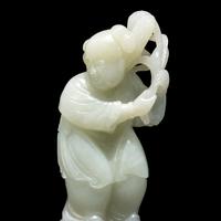 A Chinese Pale Celadon Jade Figure of a Boy, 18th-19th Century 清中期 青白玉 持蓮 童子