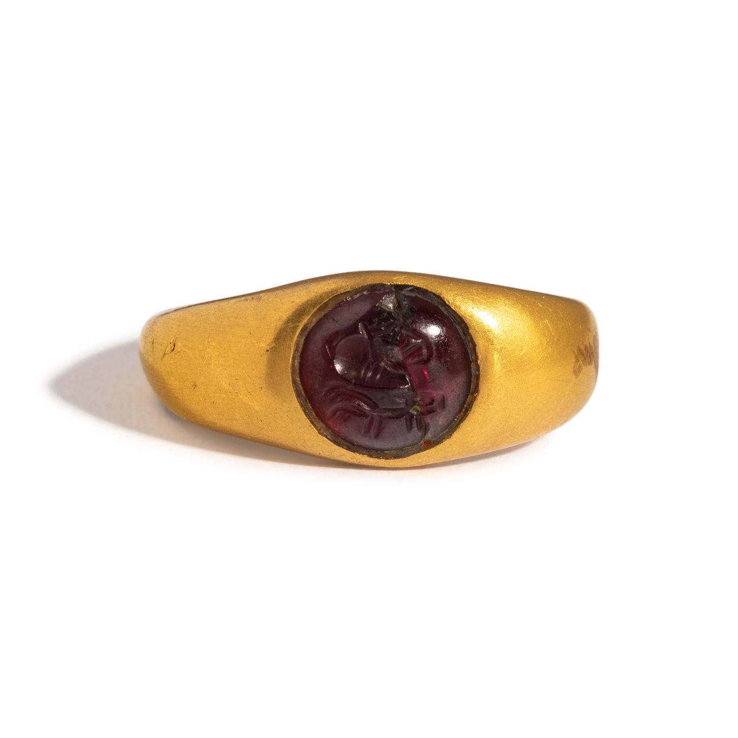 A Greek Gold and Garnet Finger Ring with a Prancing Stag