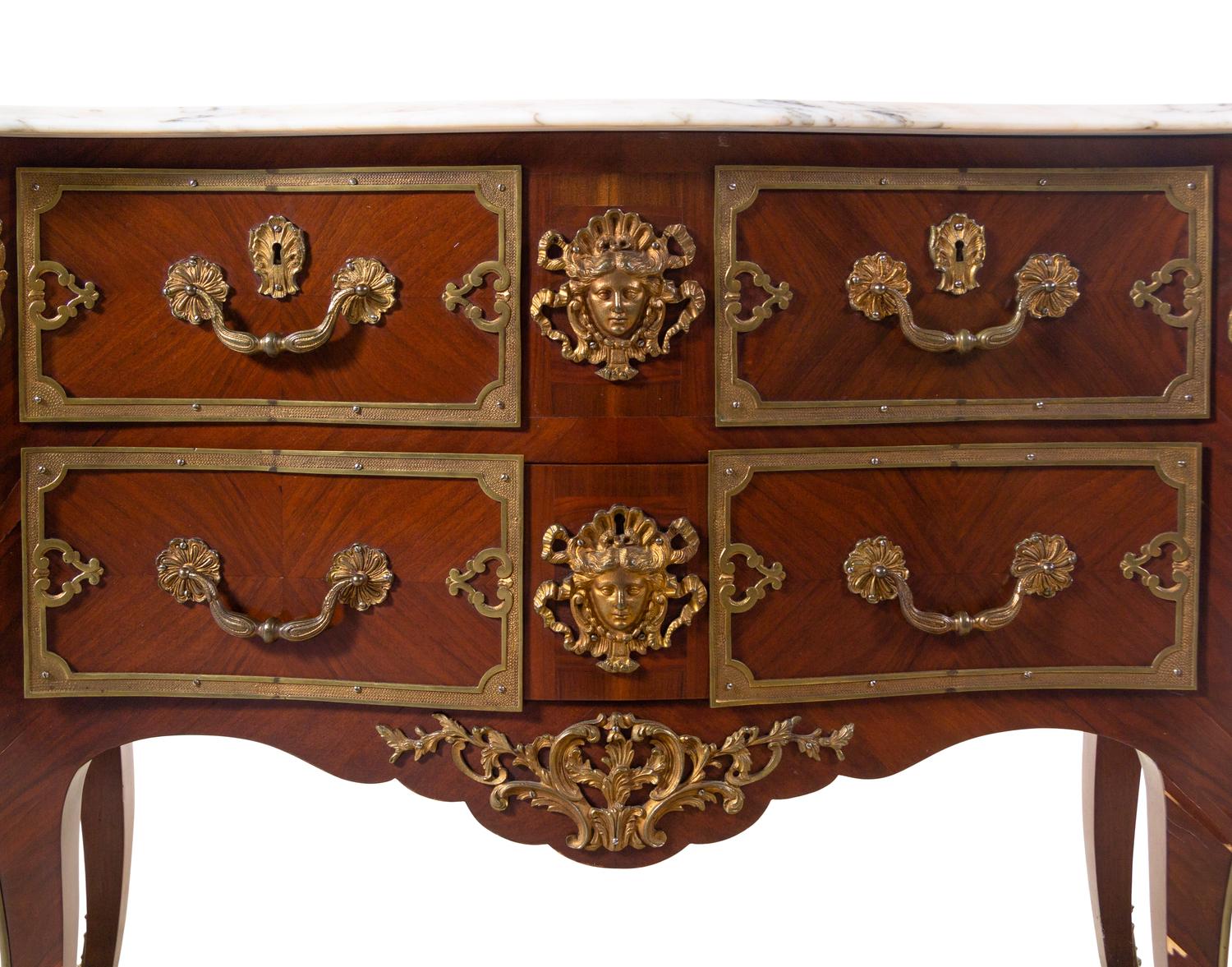 A Pair of Régence Style Gilt Bronze Mounted Marble-Top Commodes