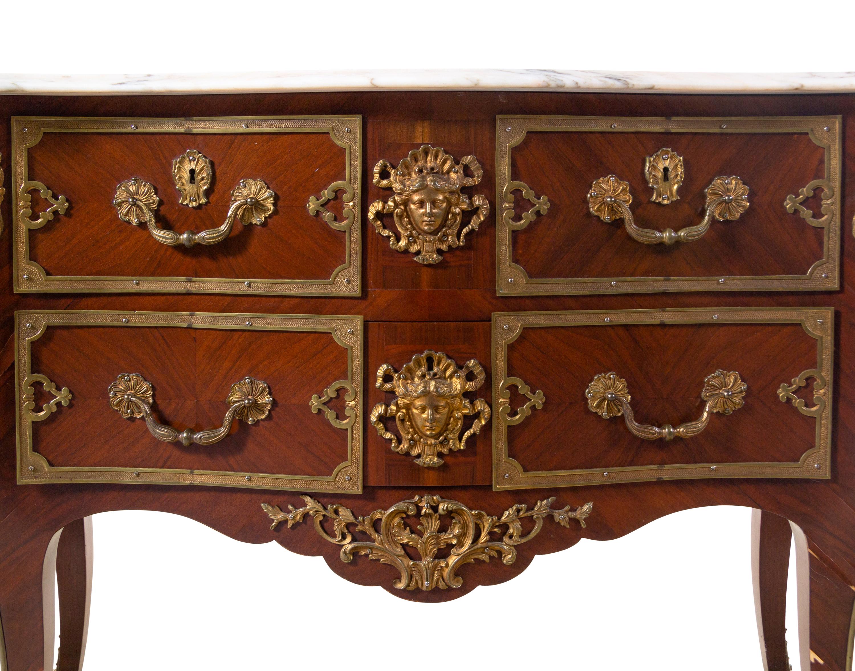 A Pair of Régence Style Gilt Bronze Mounted Marble-Top Commodes