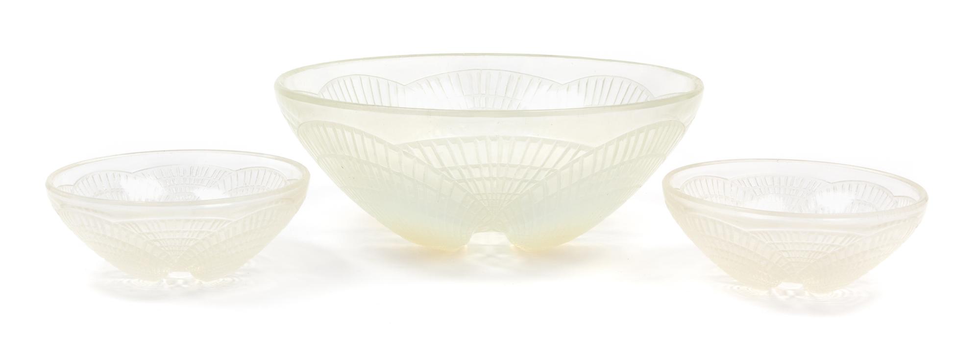 A Set of Three R. Lalique Molded Glass Bowls Diameter of largest 9 inches.