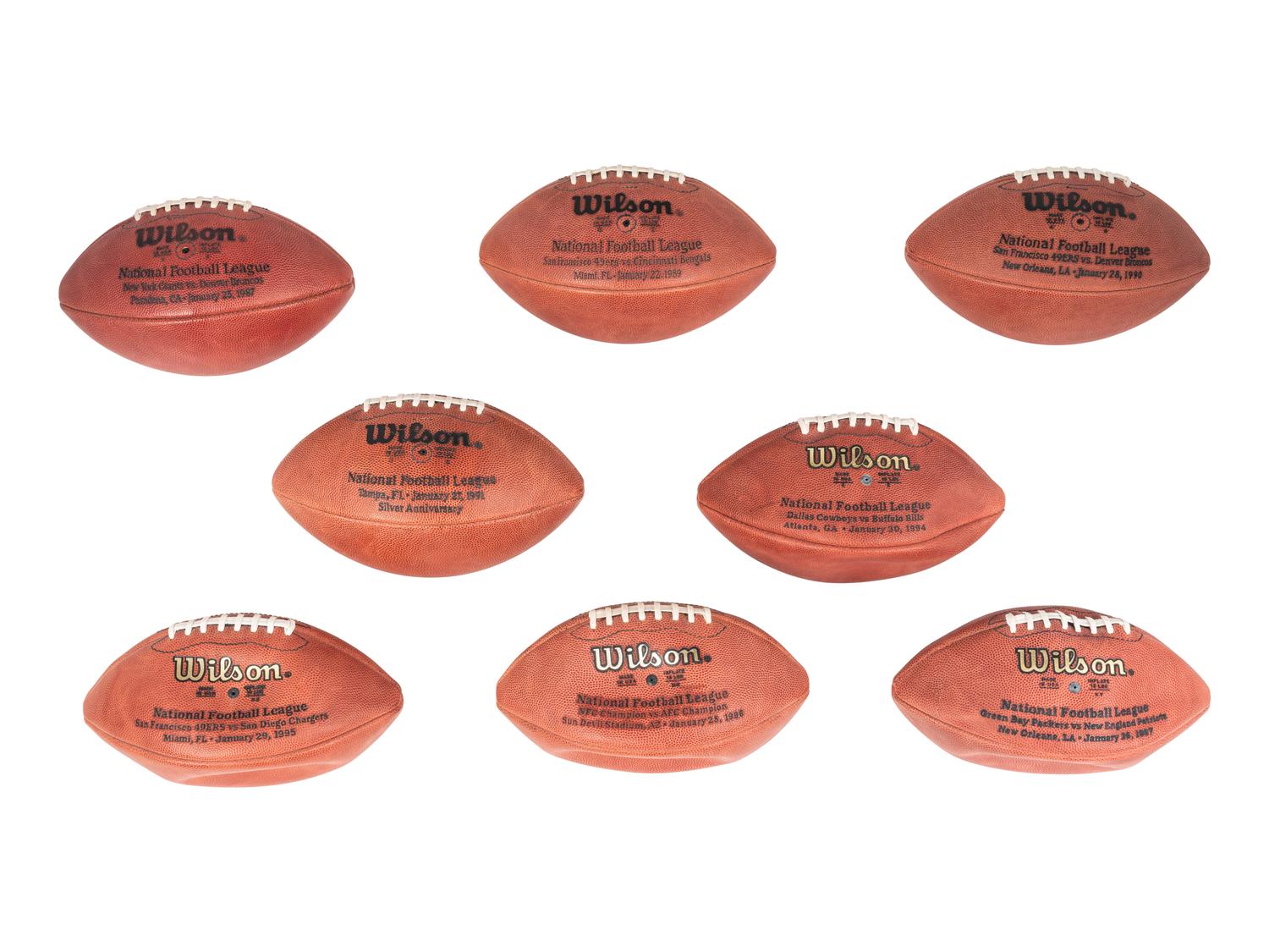 A Group of Eight Wilson Super Bowl Official Footballs and Promotional Poster,