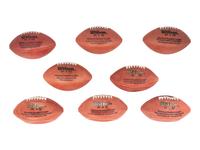 A Group of Eight Wilson Super Bowl Official Footballs and Promotional Poster,