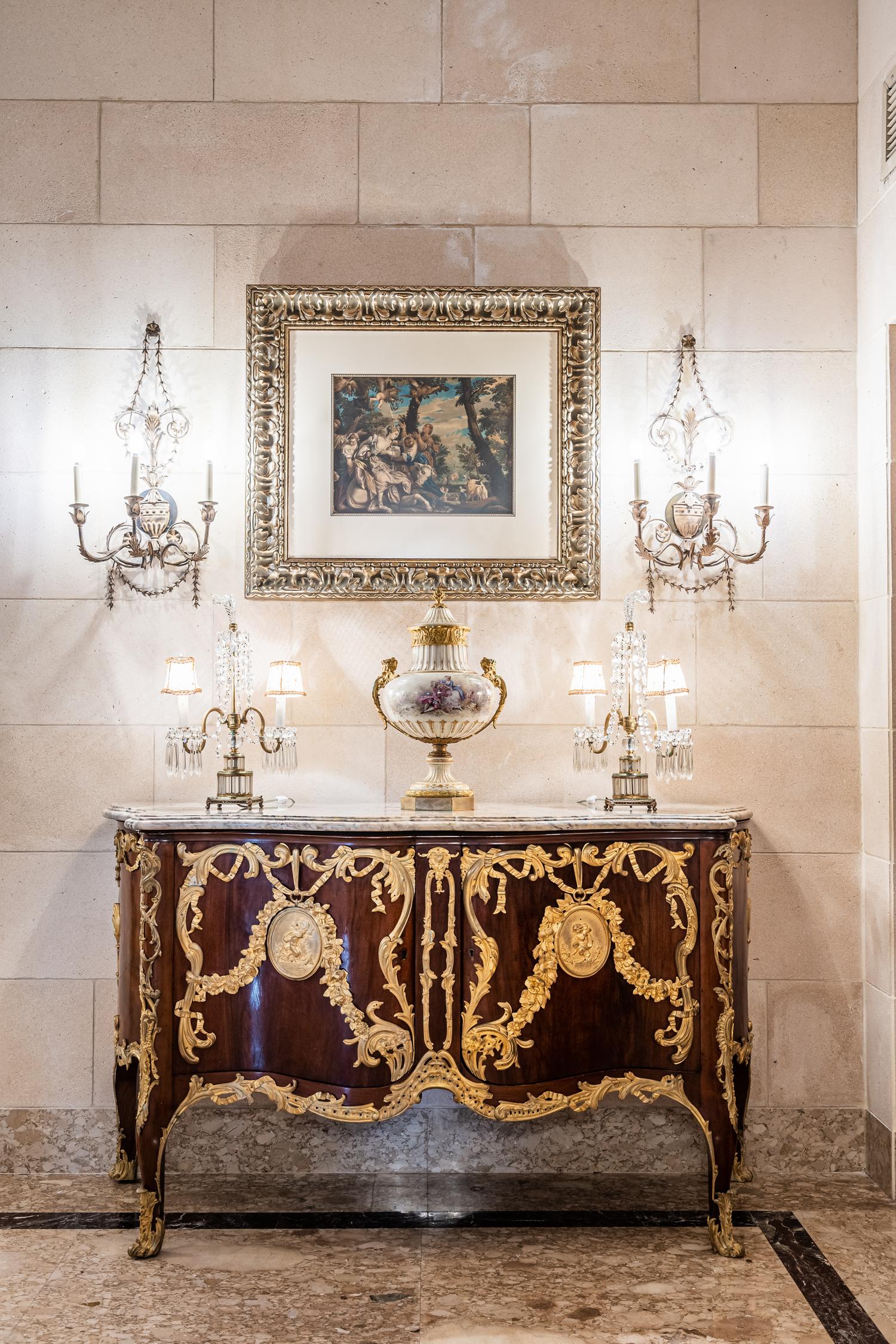 A Set of Four Neoclassical Style Pressed Metal Two-Light Sconces