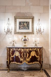 A Set of Four Neoclassical Style Pressed Metal Two-Light Sconces