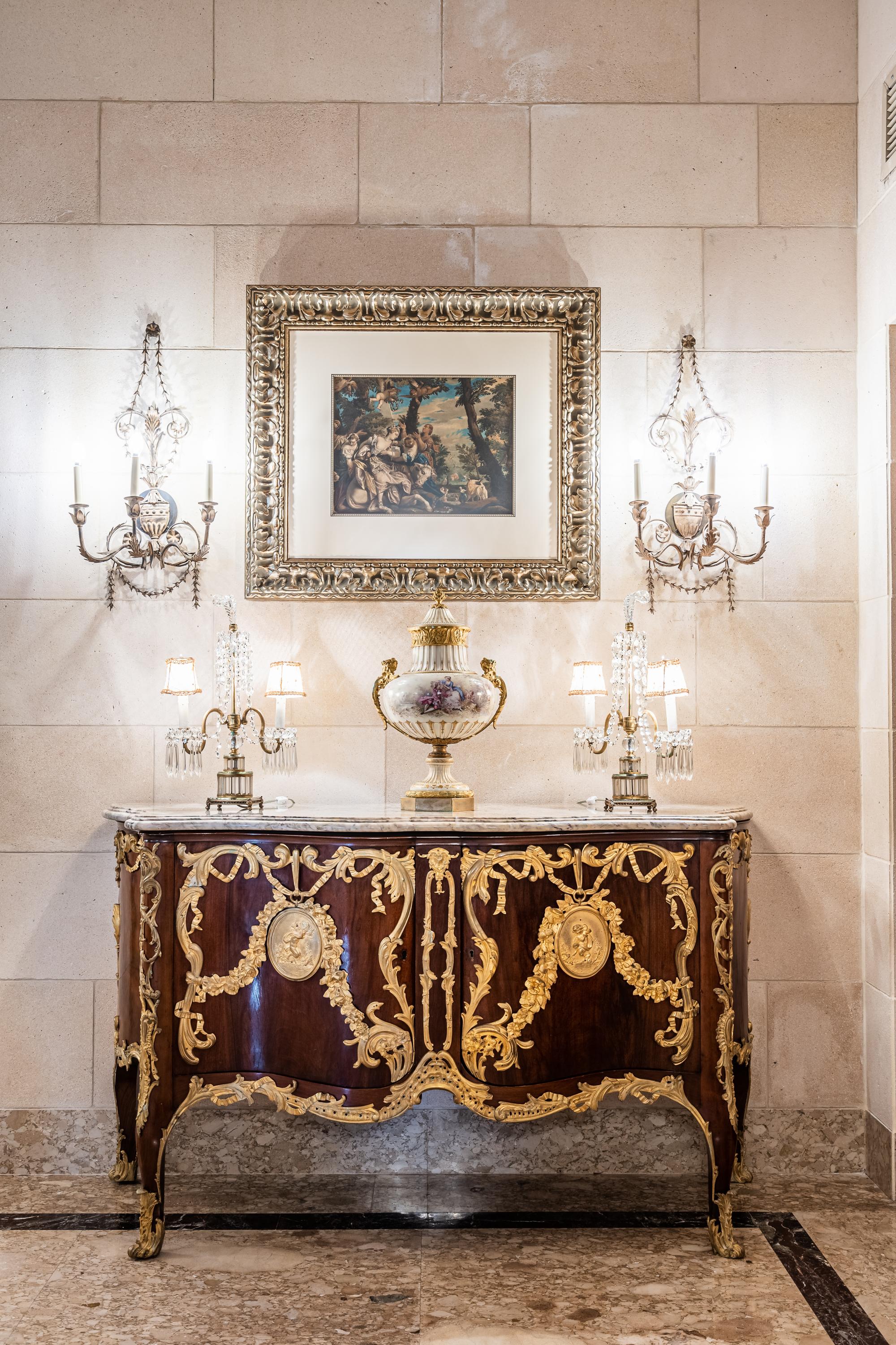 A Set of Four Neoclassical Style Pressed Metal Two-Light Sconces