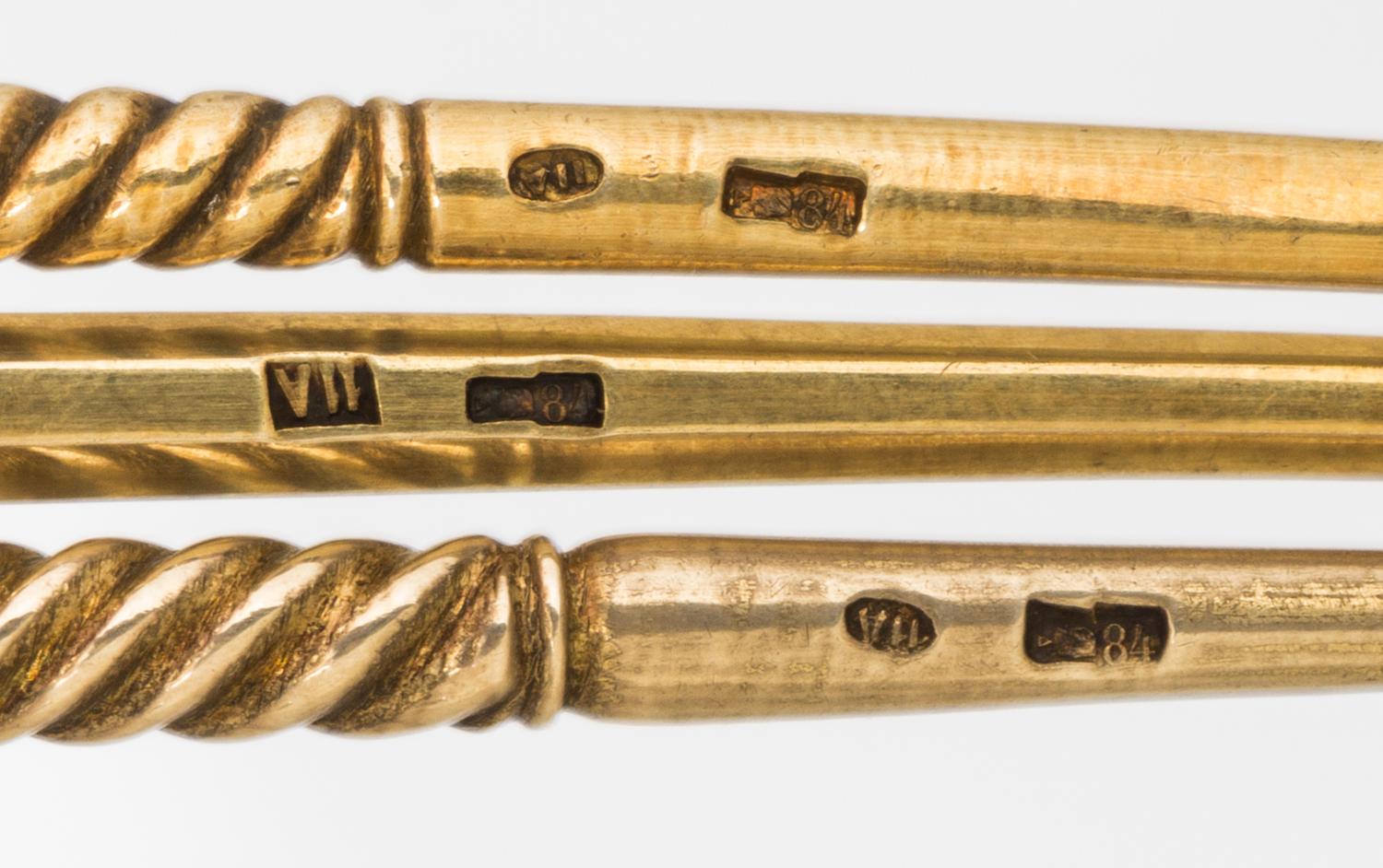 A Group of Three Russian Silver-Gilt and Enamel Spoons, Mark of 11th Artel, Moscow, early 20th century, each having an enameled finial,
