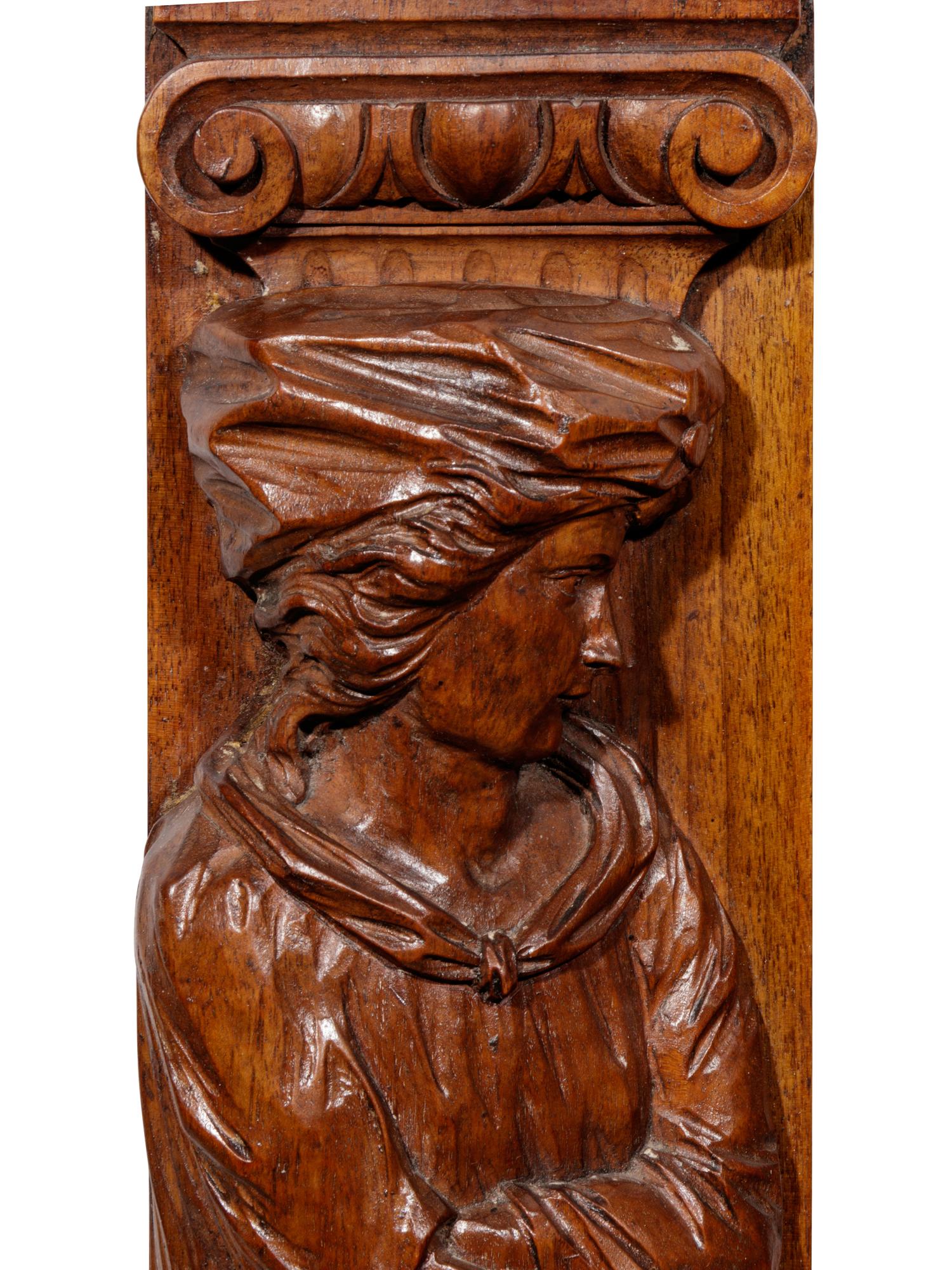 A Pair of Carved Oak Figural Pilasters