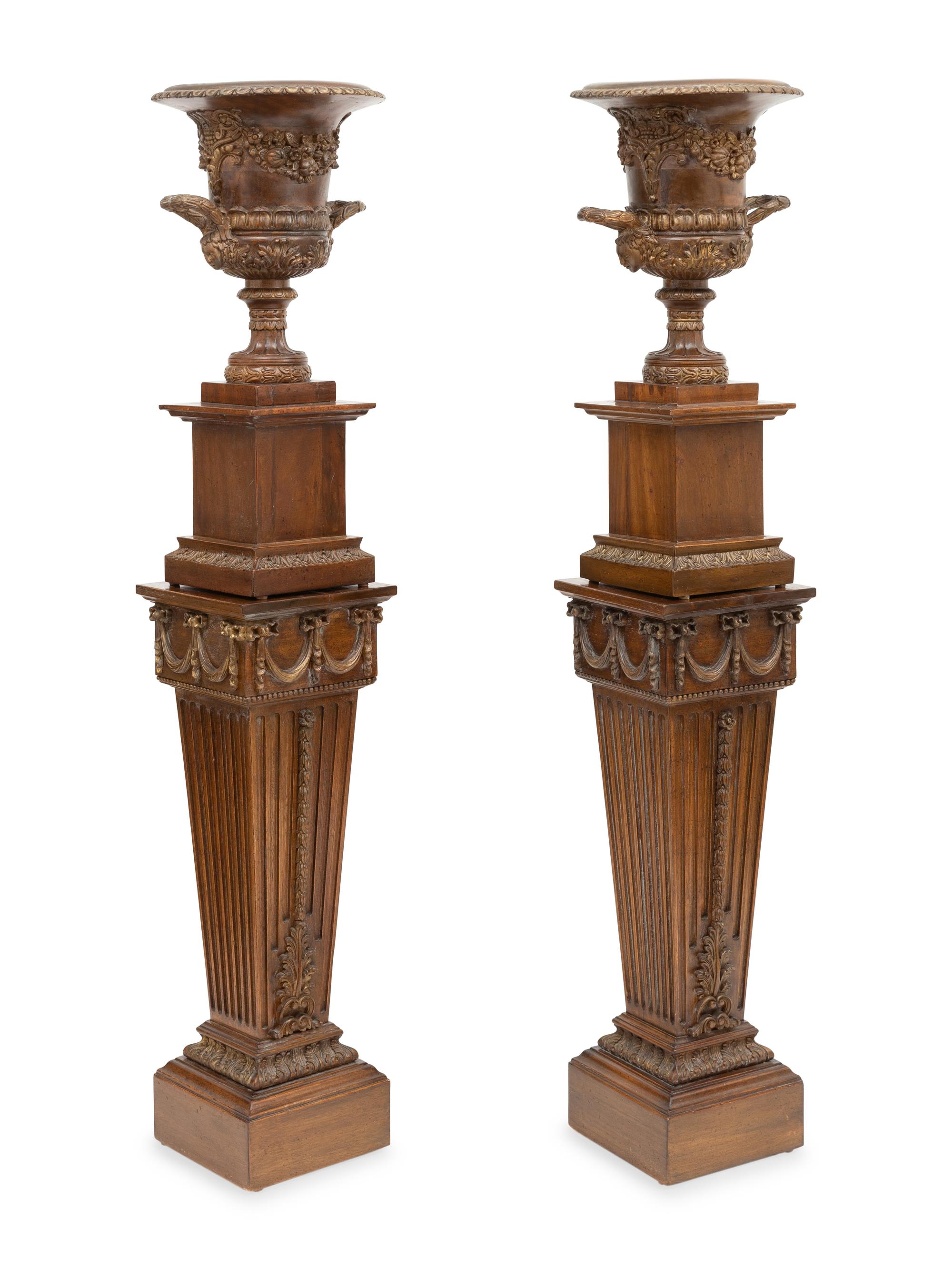 A Pair of Neoclassical Style Carved Campagna Form Urns on Pedestals