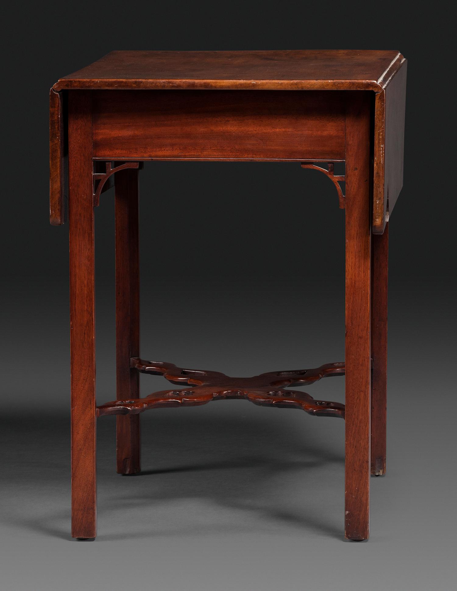 A Late Chippendale Carved and Figured Mahogany Stretcher-Base Pembroke Table