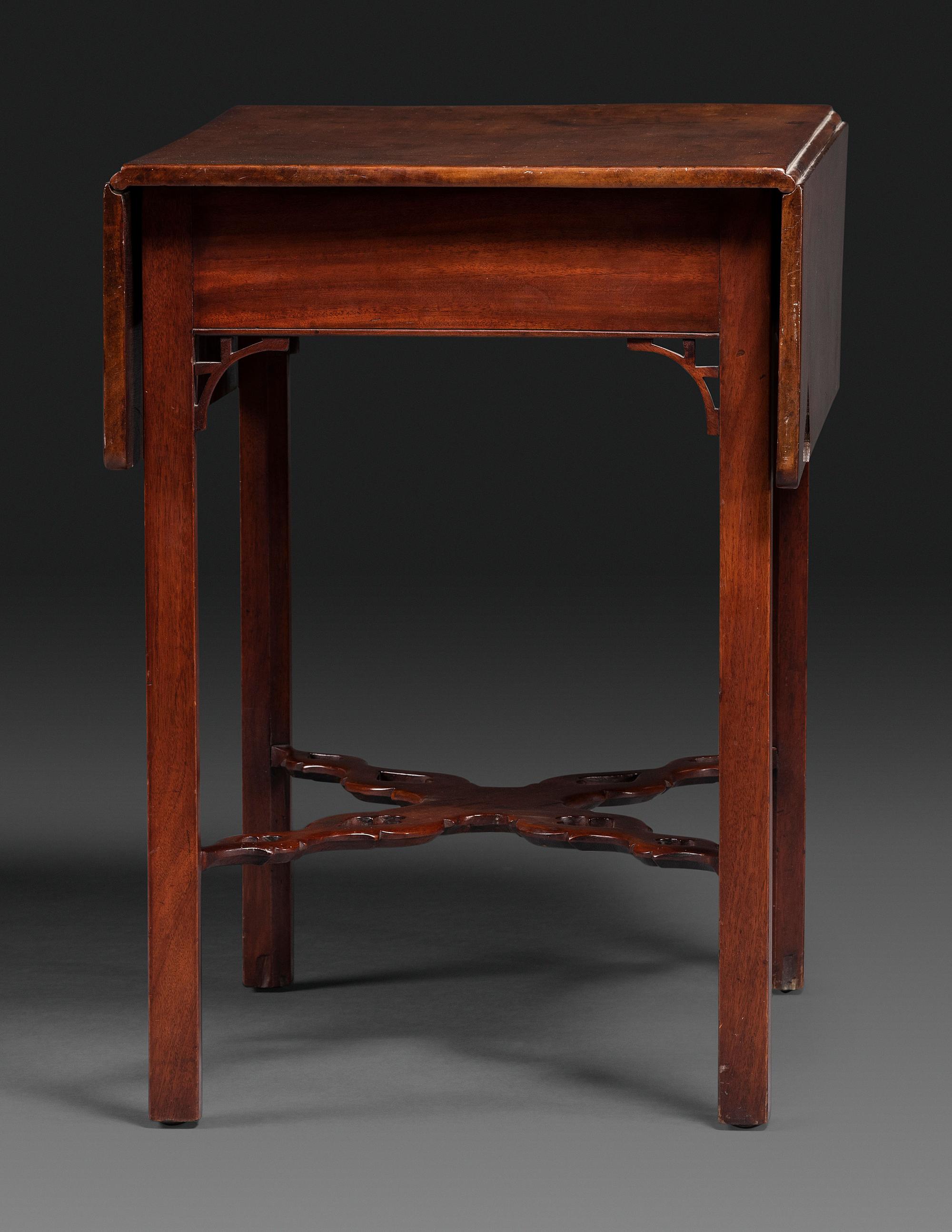 A Late Chippendale Carved and Figured Mahogany Stretcher-Base Pembroke Table
