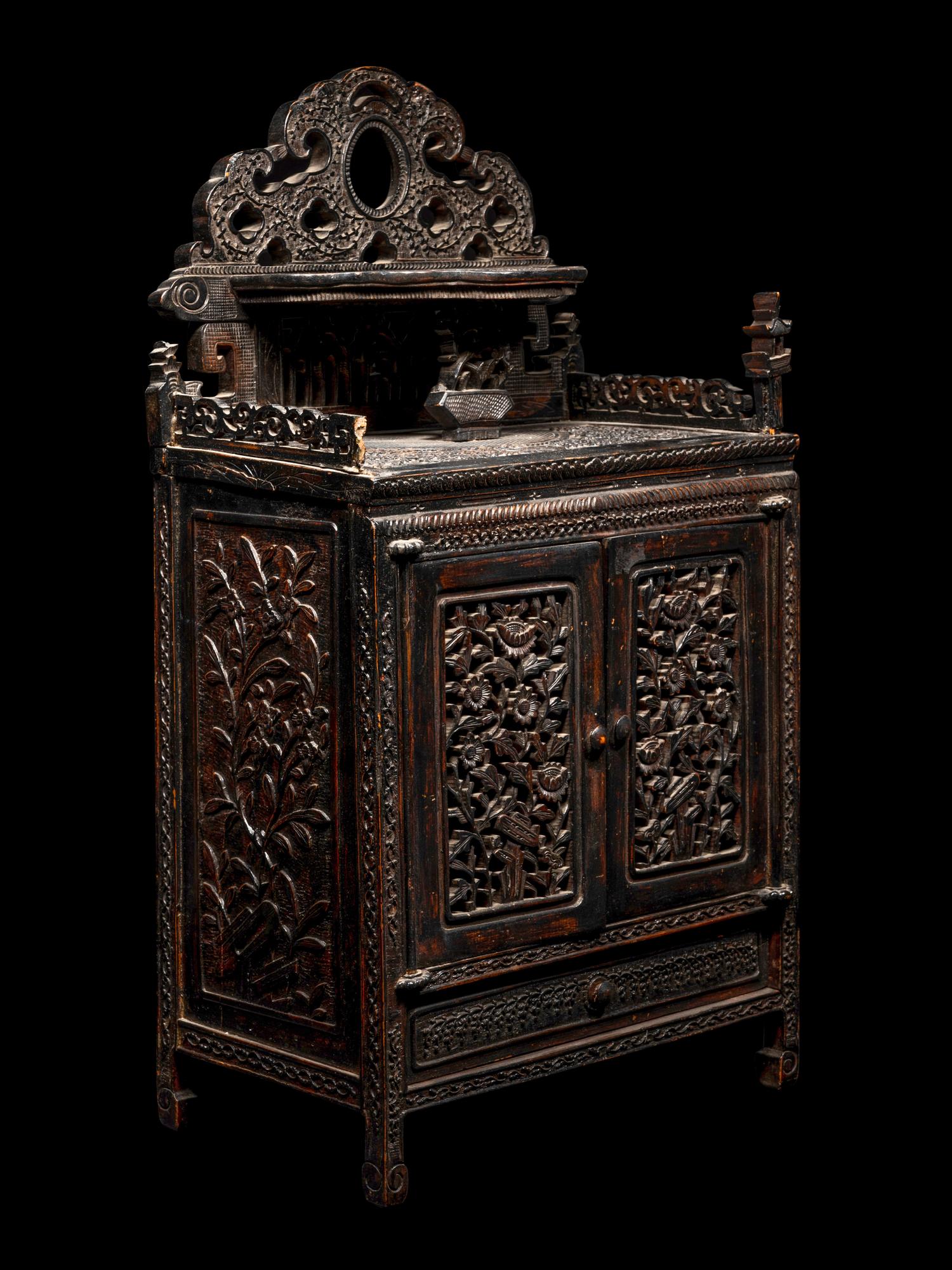 A Chinese Export Carved Hardwood Cabinet