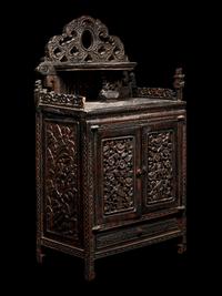 A Chinese Export Carved Hardwood Cabinet