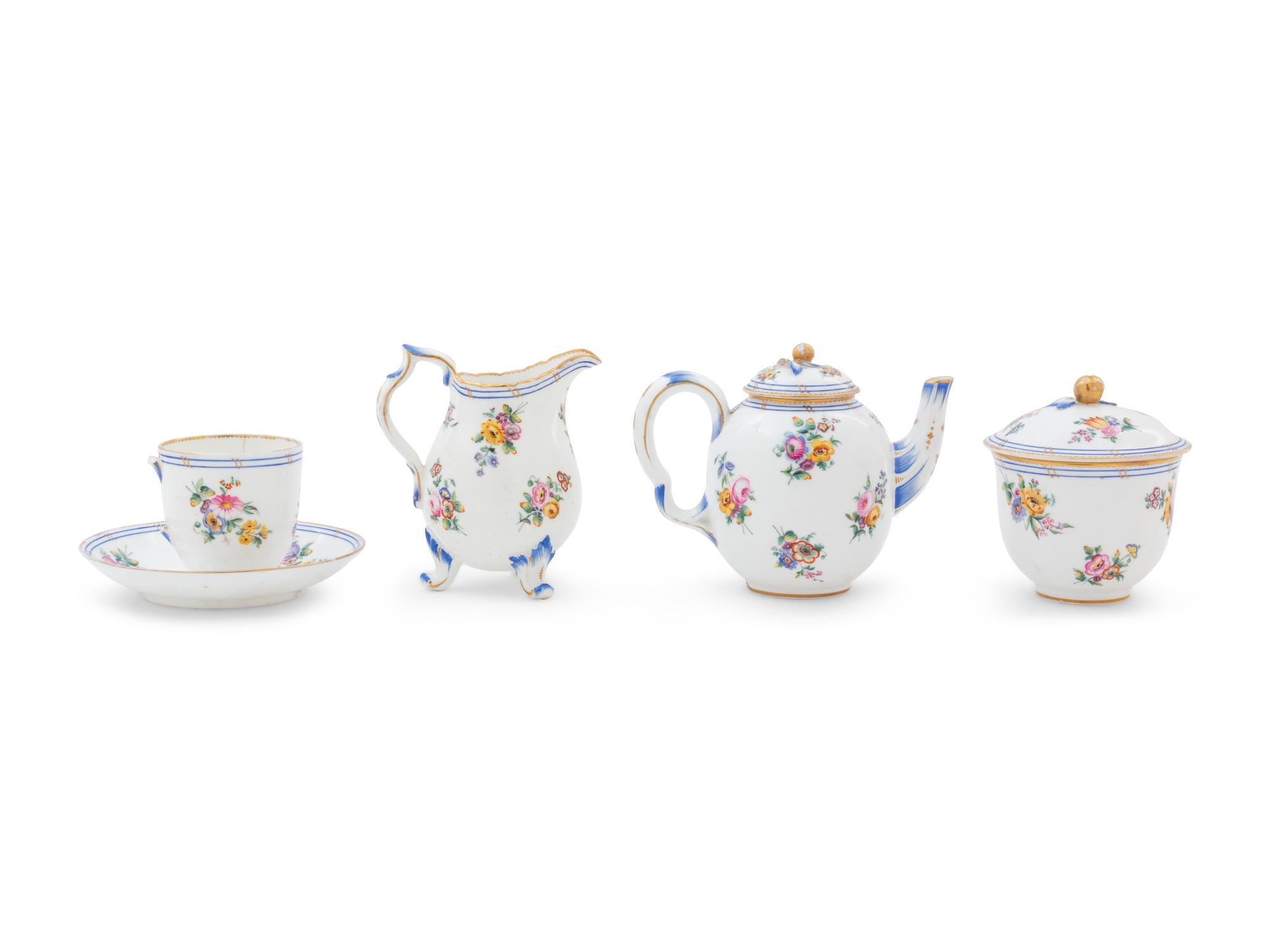 A Sèvres Painted and Parcel Gilt Porcelain Tea Service in a Mahogany and Marquetry Fitted Traveling Case