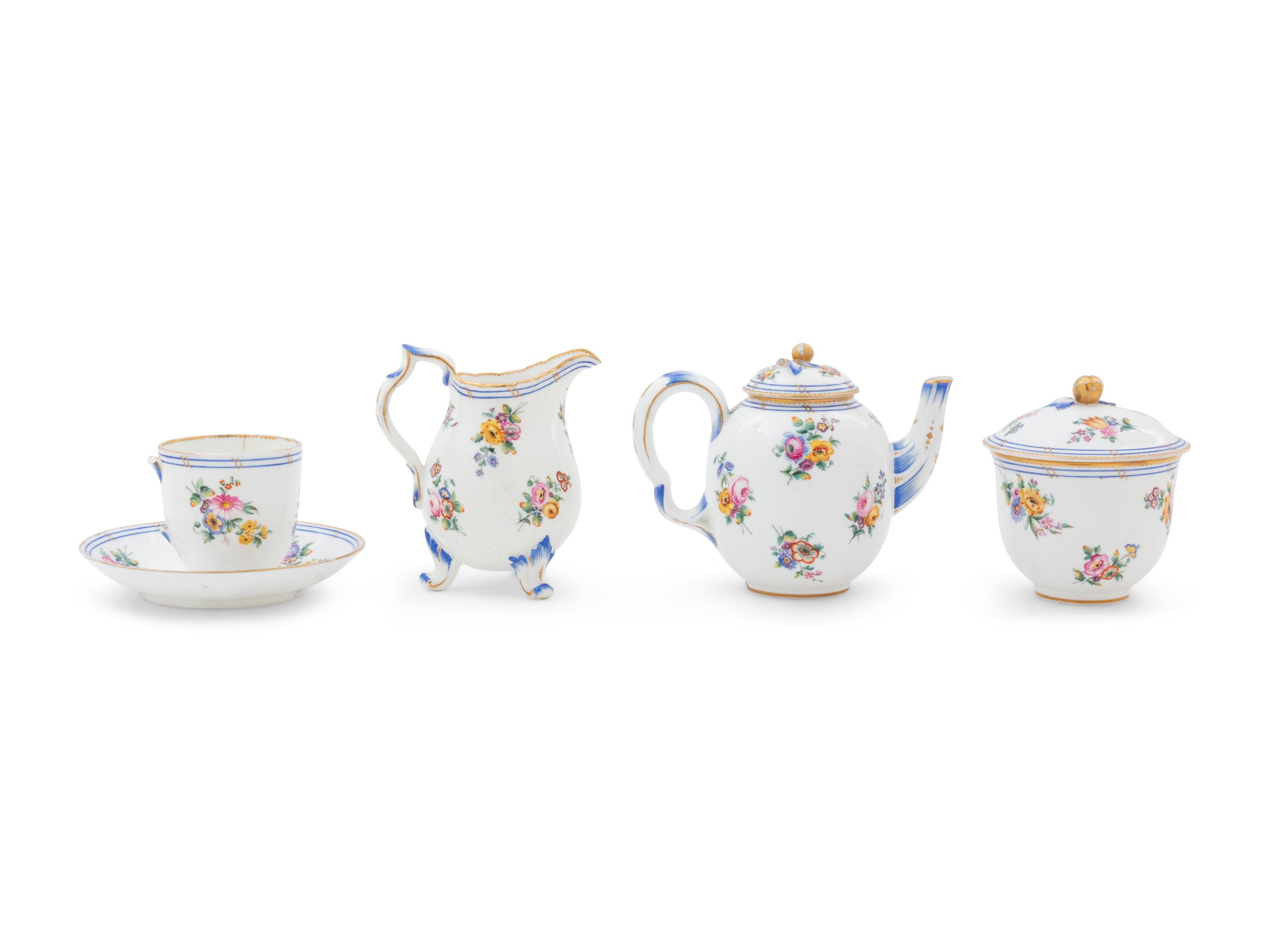 A Sèvres Painted and Parcel Gilt Porcelain Tea Service in a Mahogany and Marquetry Fitted Traveling Case