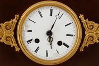 An Empire Style Gilt and Patinated Bronze Mantel Clock
