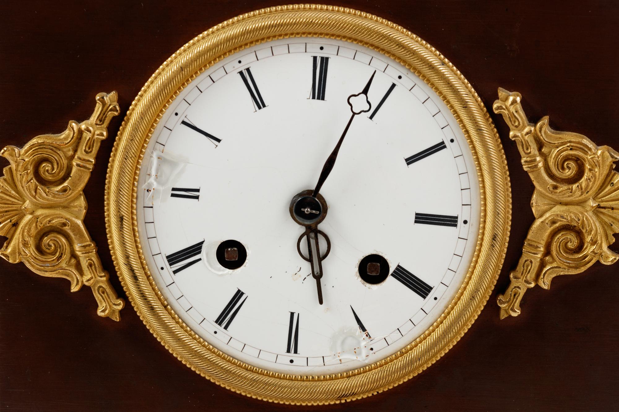 An Empire Style Gilt and Patinated Bronze Mantel Clock