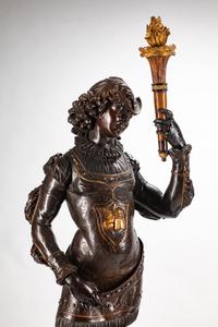 A Large Pair of English Parcel-Gilt and Stained Wood Figural Torchères on Stands