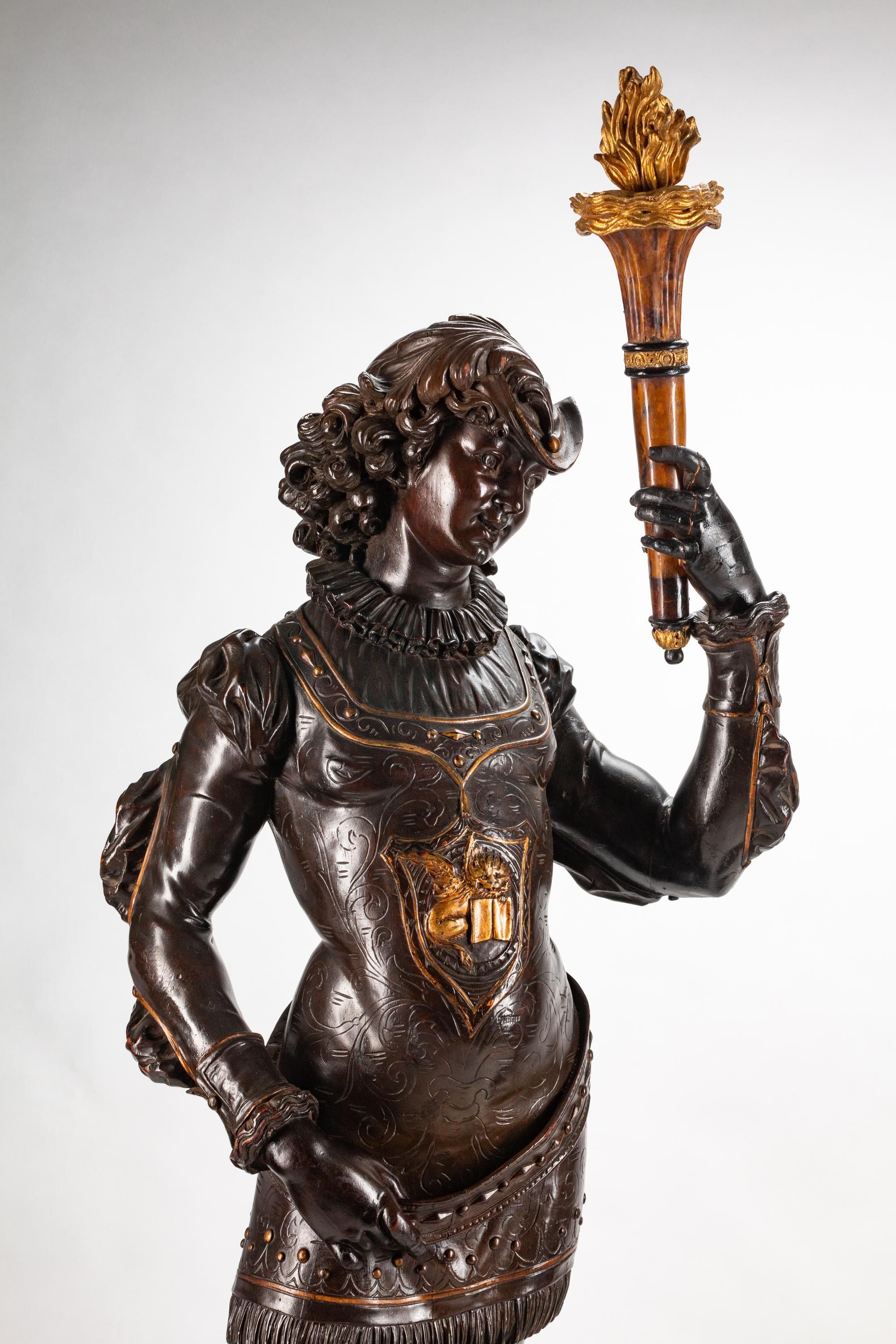 A Large Pair of English Parcel-Gilt and Stained Wood Figural Torchères on Stands