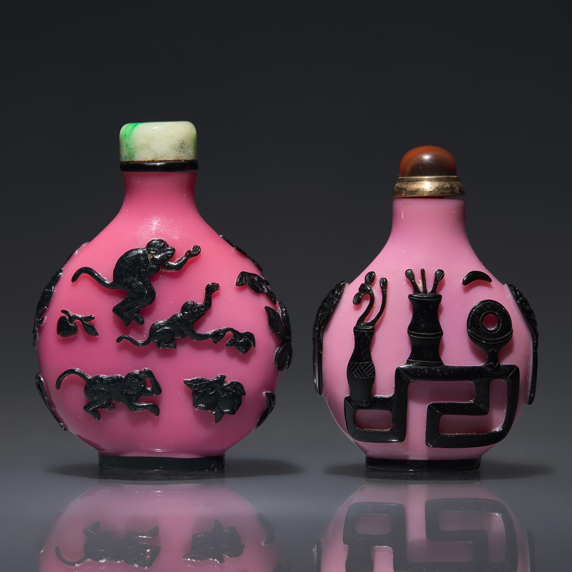 Two Chinese Carved Black-Overlaid Pink Glass Snuff Bottles, Qing Dynasty, Circa 1780-1900 — 1780-1900年 粉紅地套黑料鼻煙壺兩支