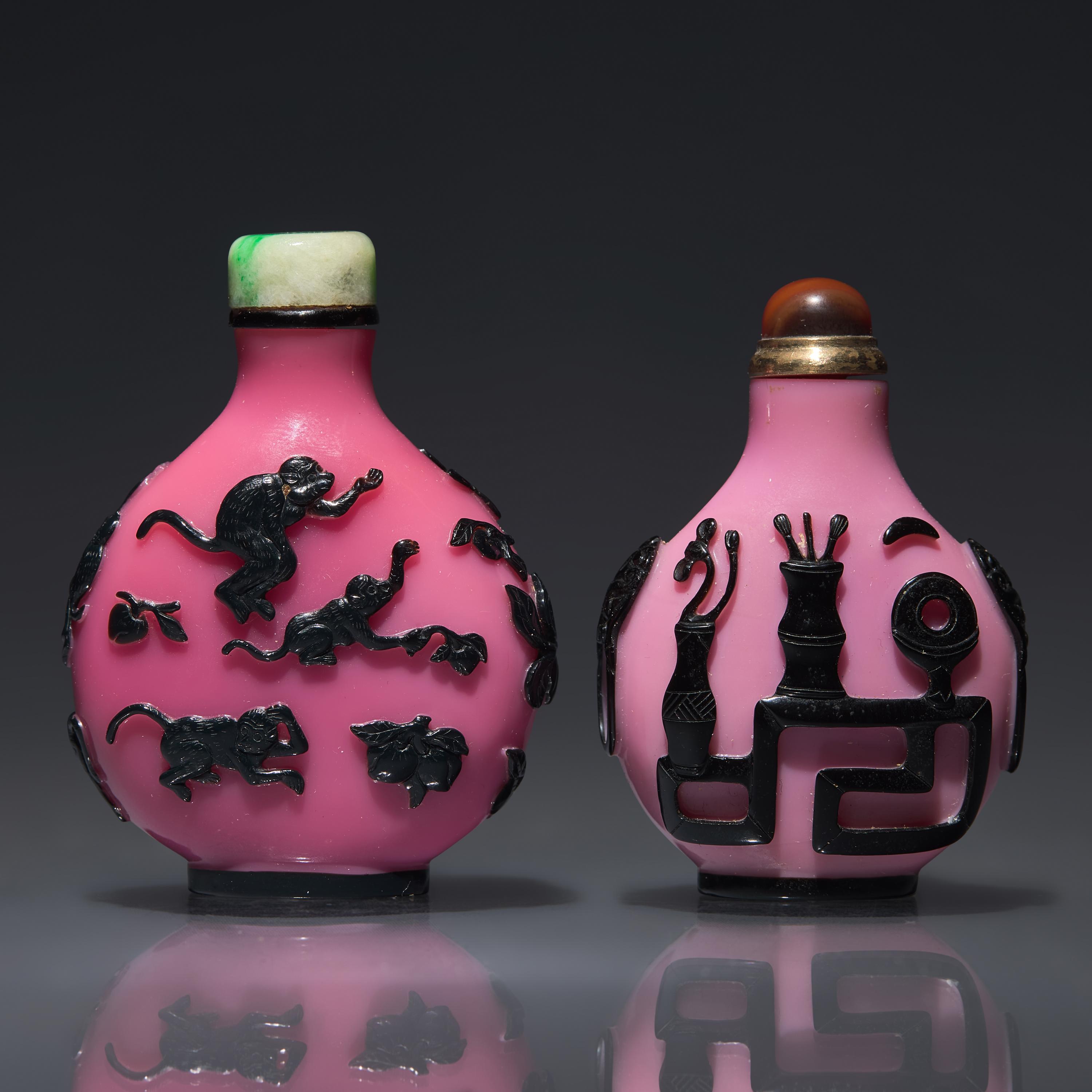 Two Chinese Carved Black-Overlaid Pink Glass Snuff Bottles, Qing Dynasty, Circa 1780-1900 — 1780-1900年 粉紅地套黑料鼻煙壺兩支