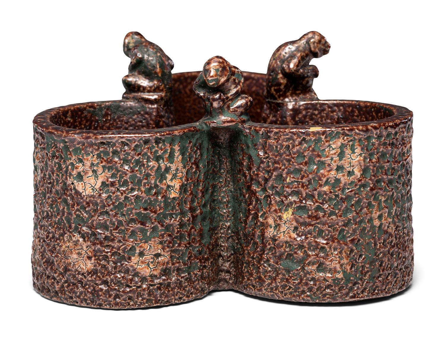 A Glazed Sewer Tile Trefoil Vase or Planter with Seated Monkeys