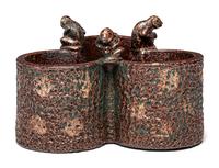 A Glazed Sewer Tile Trefoil Vase or Planter with Seated Monkeys