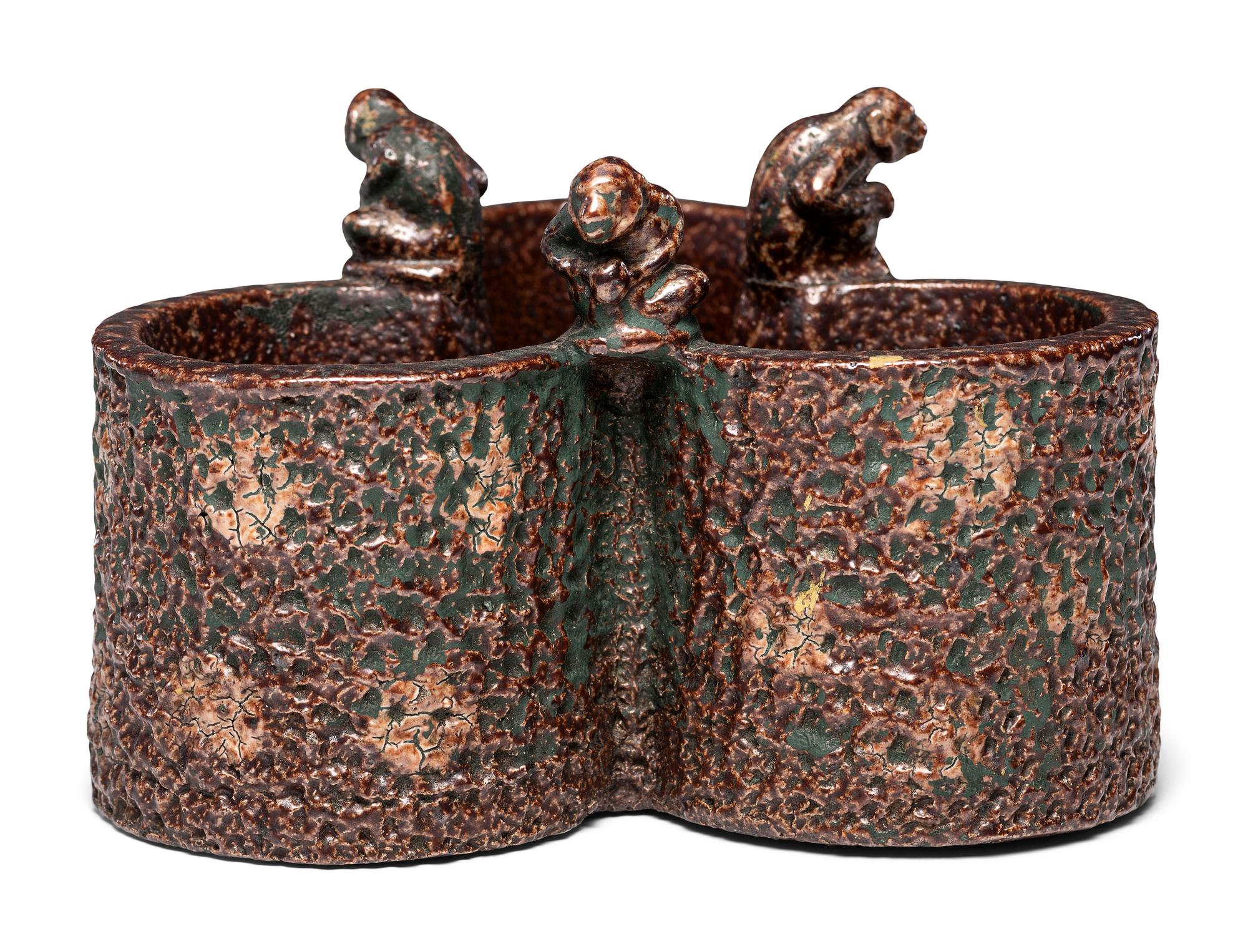 A Glazed Sewer Tile Trefoil Vase or Planter with Seated Monkeys