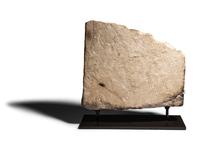 An Egyptian Limestone Relief Fragment with Serving Woman