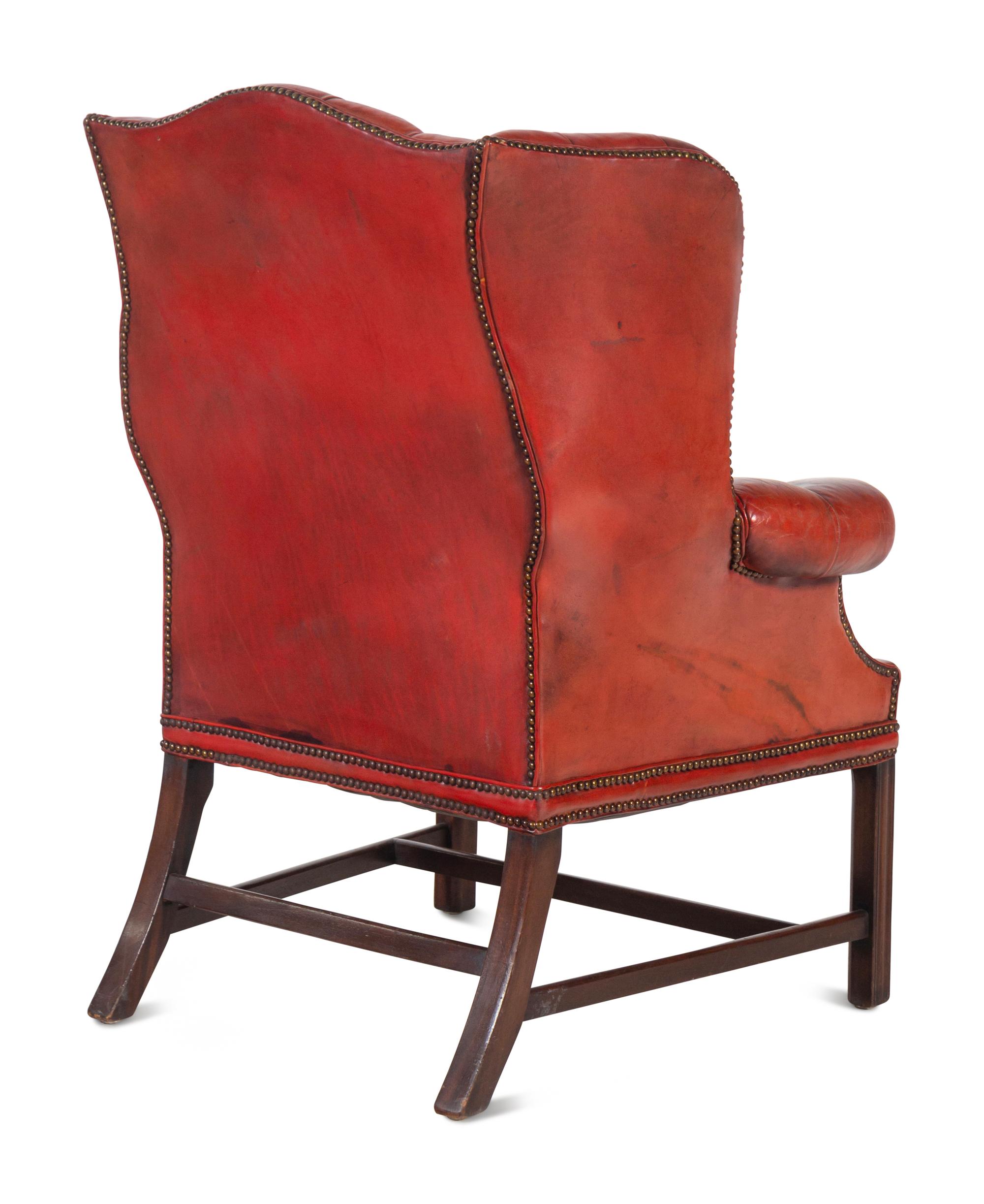 A Pair of Leather Wingback Armchairs with Ottoman