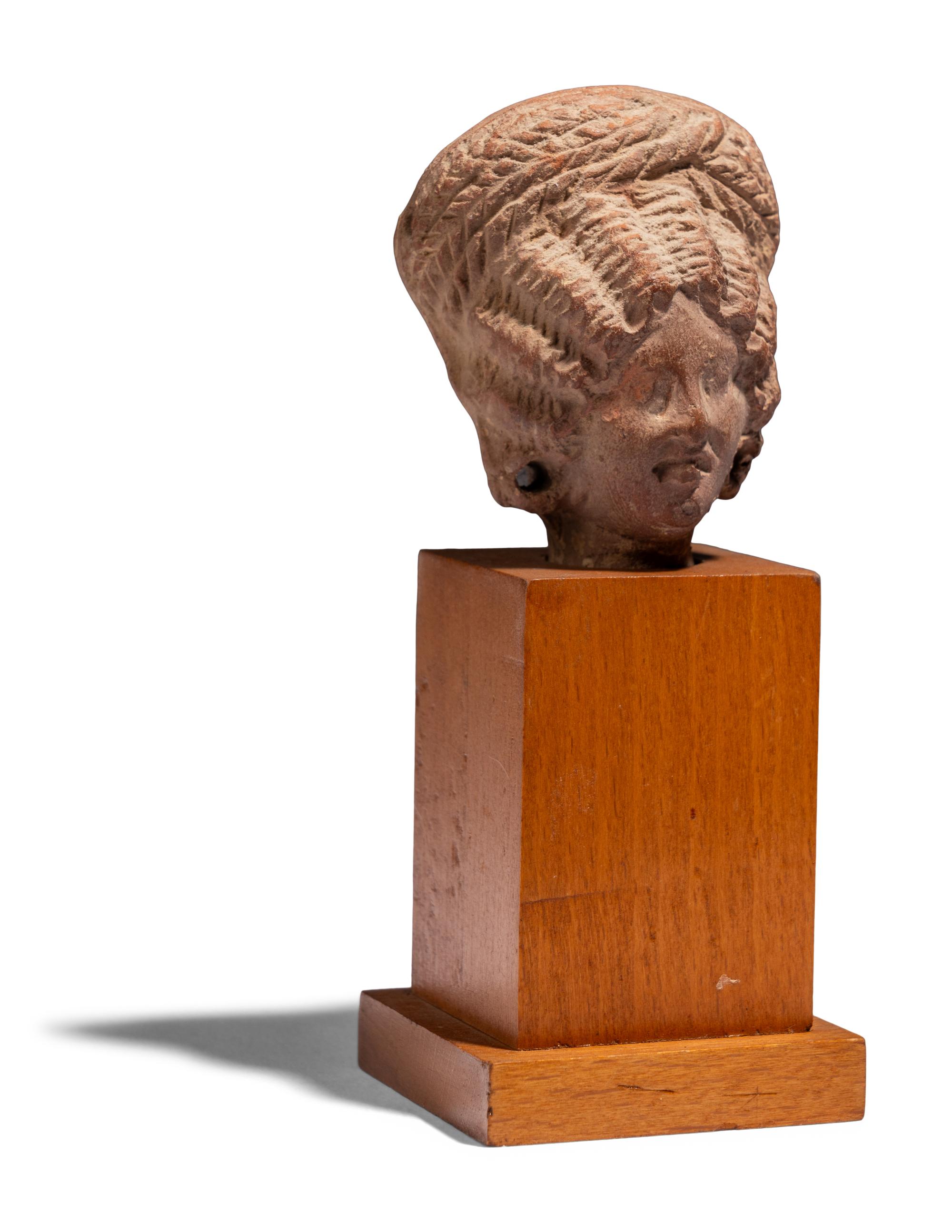 An Egyptian Terracotta Head of a Woman