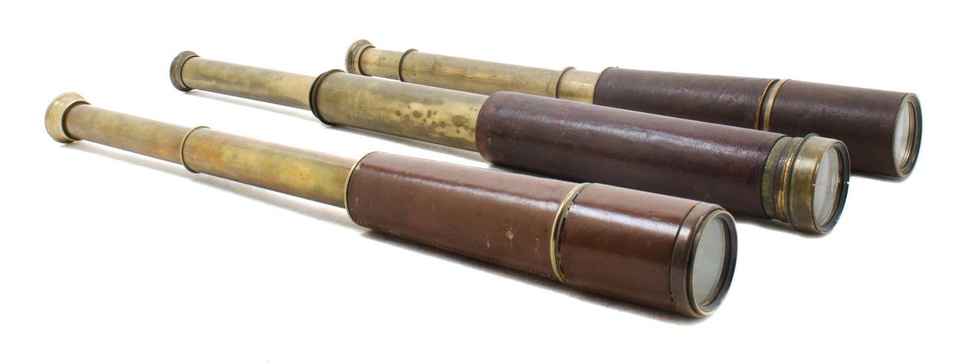 A Group of Three Leather Body Hand Telescopes Length of longest 11 1/2 inches (when collapsed).