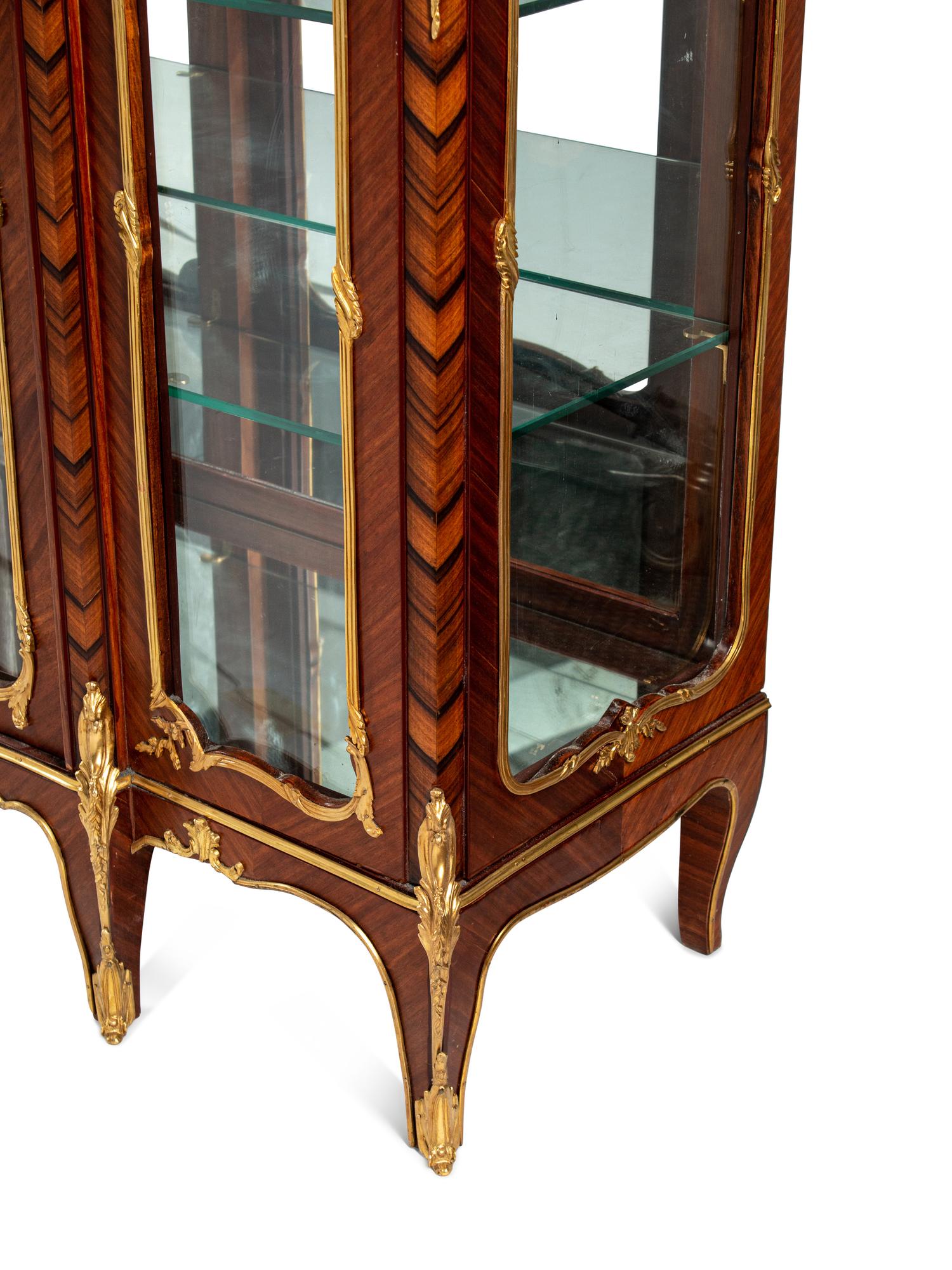 A Pair of Louis XV Style Gilt Bronze Mounted Kingwood and Rosewood Marble-Top Vitrine Cabinets