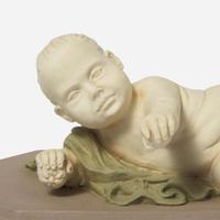 A Wedgwood Tricolor Jasperware Figure of a Reclining Infant UK, circa 1800