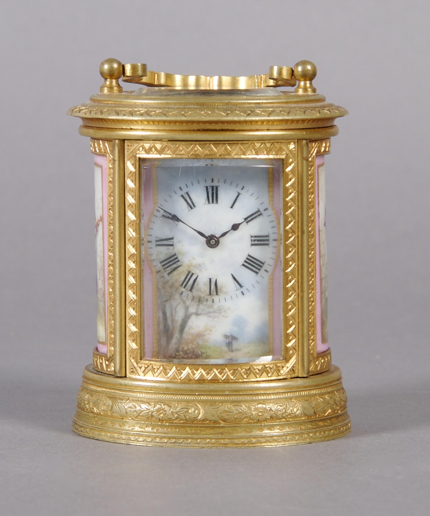 A French Gilt Bronze and Porcelain Mounted Carriage Clock, retailed by Tiffany & Co., Height over handle 4 inches.