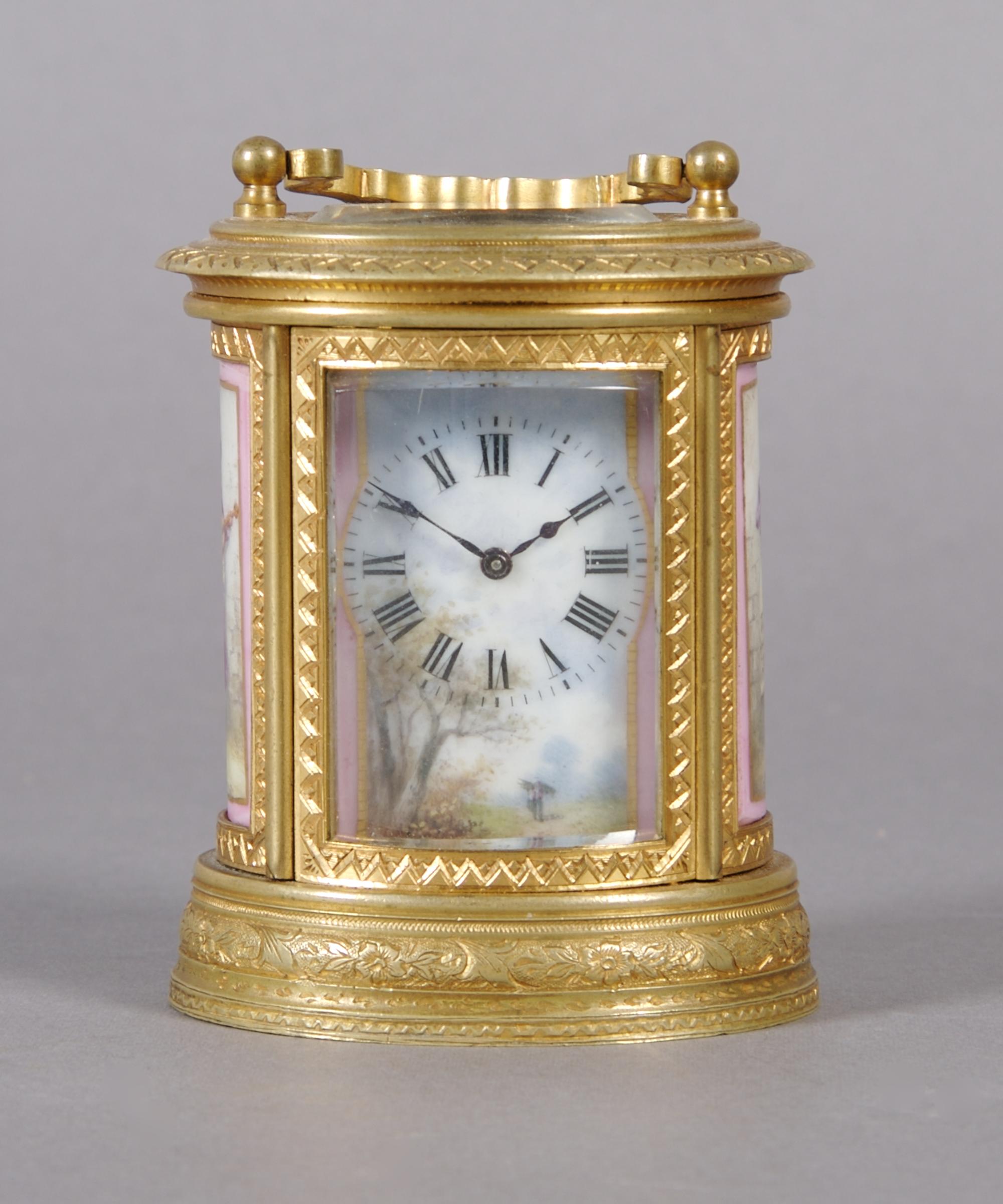 A French Gilt Bronze and Porcelain Mounted Carriage Clock, retailed by Tiffany & Co., Height over handle 4 inches.