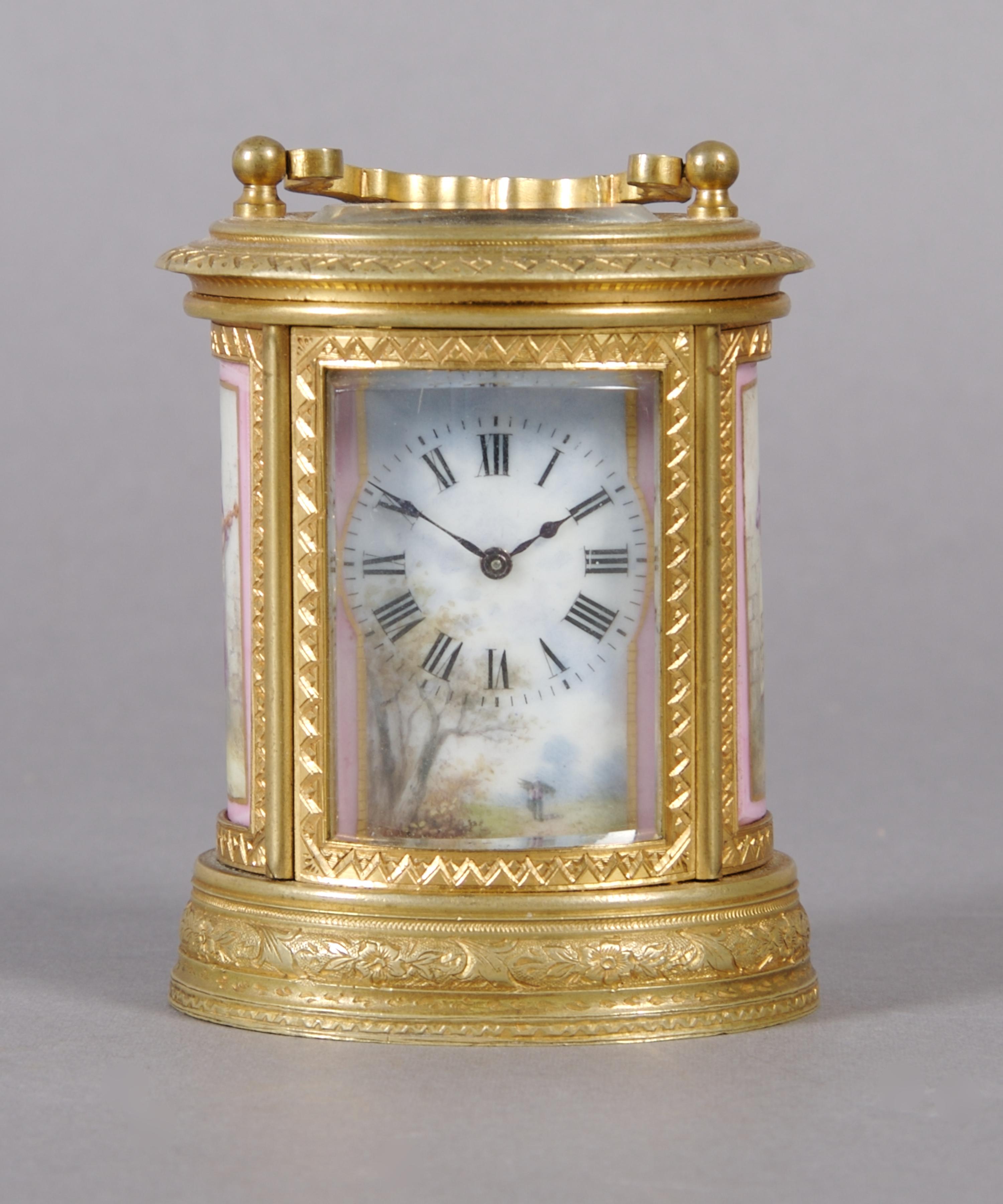 A French Gilt Bronze and Porcelain Mounted Carriage Clock, retailed by Tiffany & Co., Height over handle 4 inches.