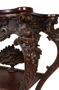 A Renaissance Revival Carved Walnut Serpentine Top Console Table