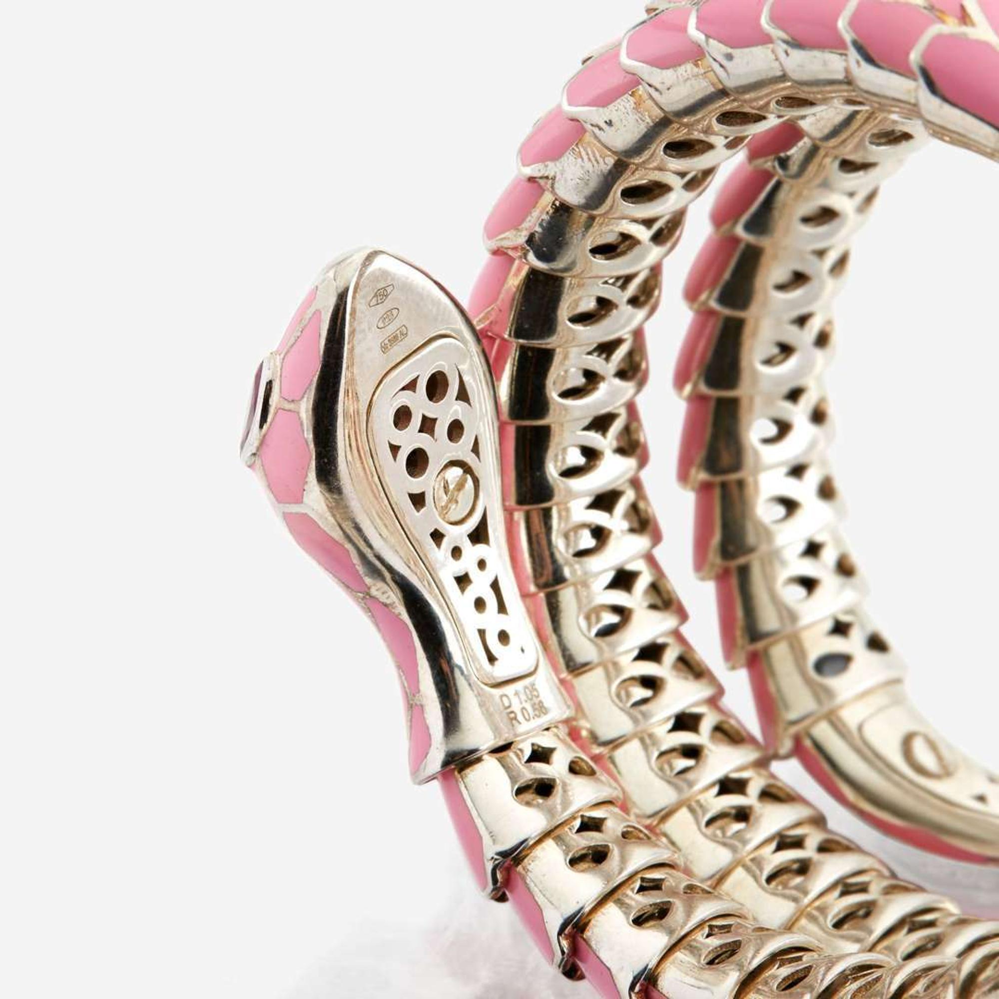 An enamel, white gold plated sterling silver, diamond, and ruby bangle