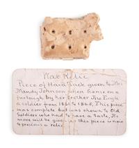 Civil War hardtack with period tag identifying it as a piece brought home by a soldier and shared with other "old soldiers."
