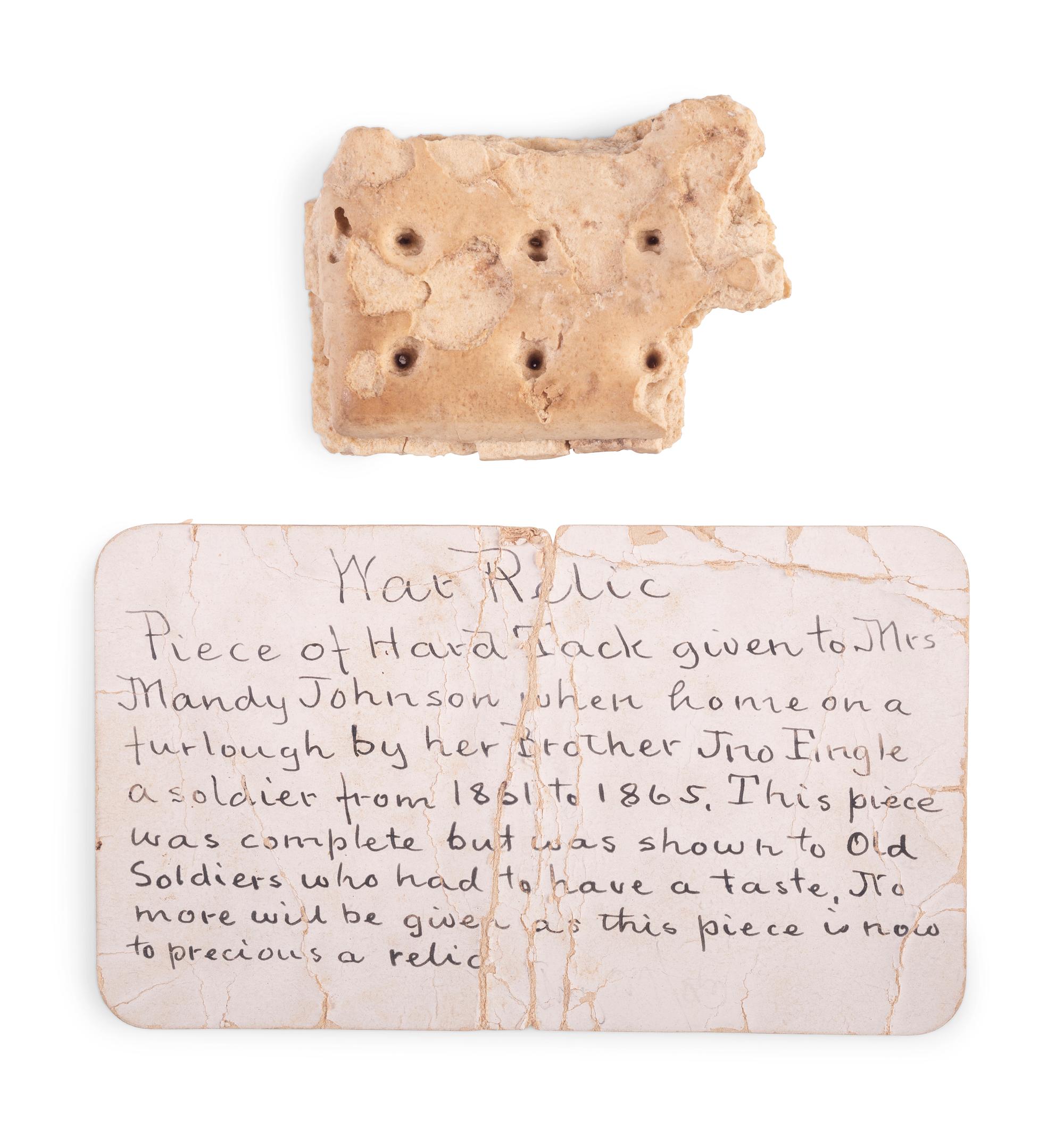 Civil War hardtack with period tag identifying it as a piece brought home by a soldier and shared with other "old soldiers."