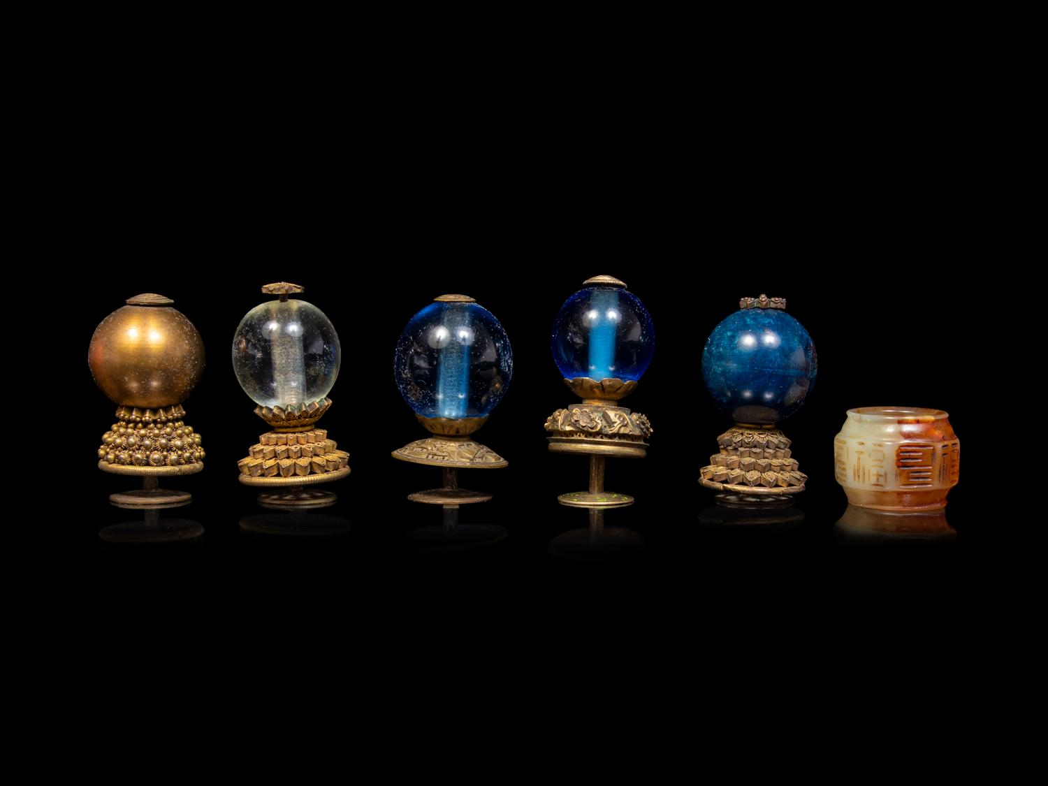 A Chinese Russet Jade Archer's Ring and Ten Chinese Hardstone and Gilt Bronze Hat Finials